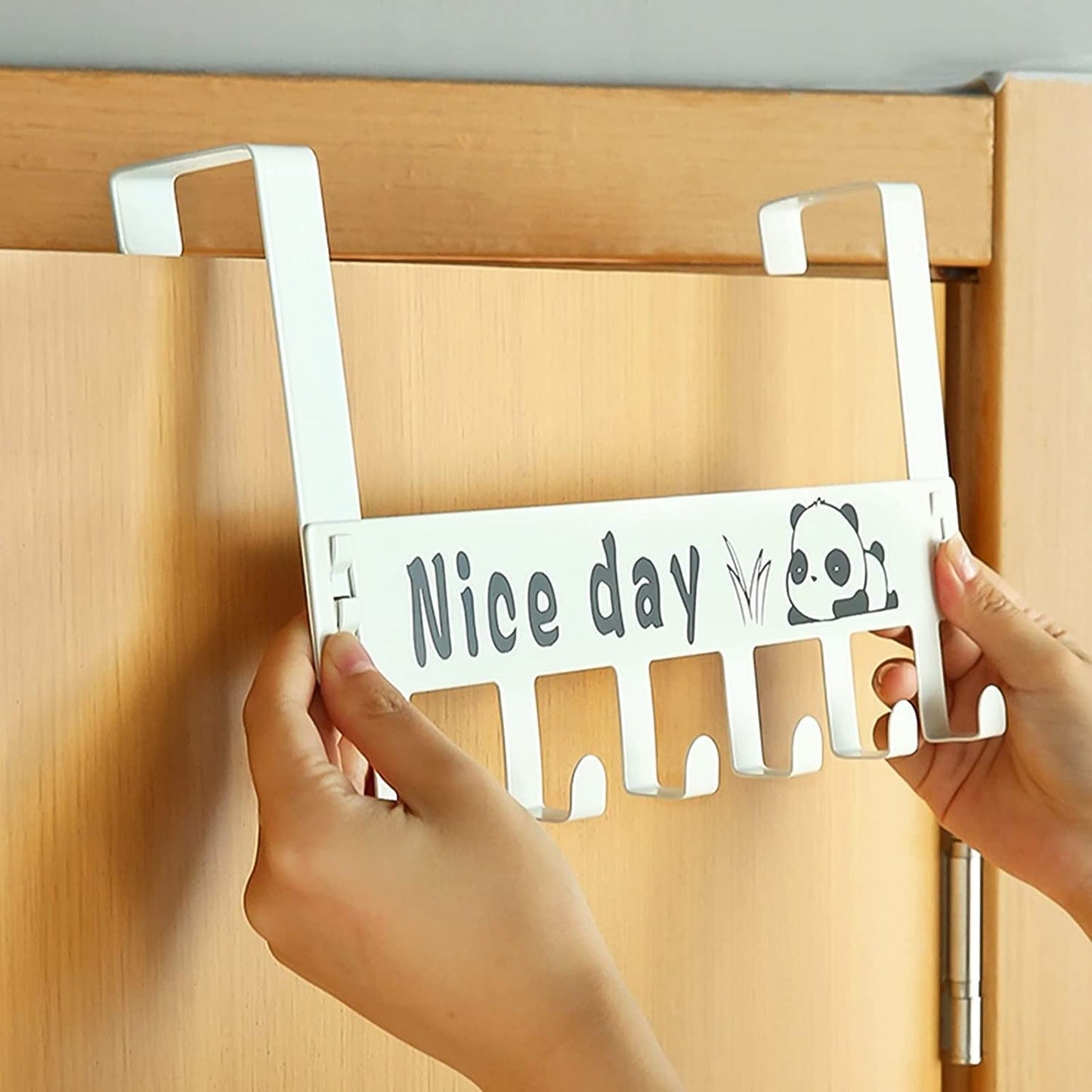 Close-up view of sturdy metal hooks on white carbon steel over door rack
