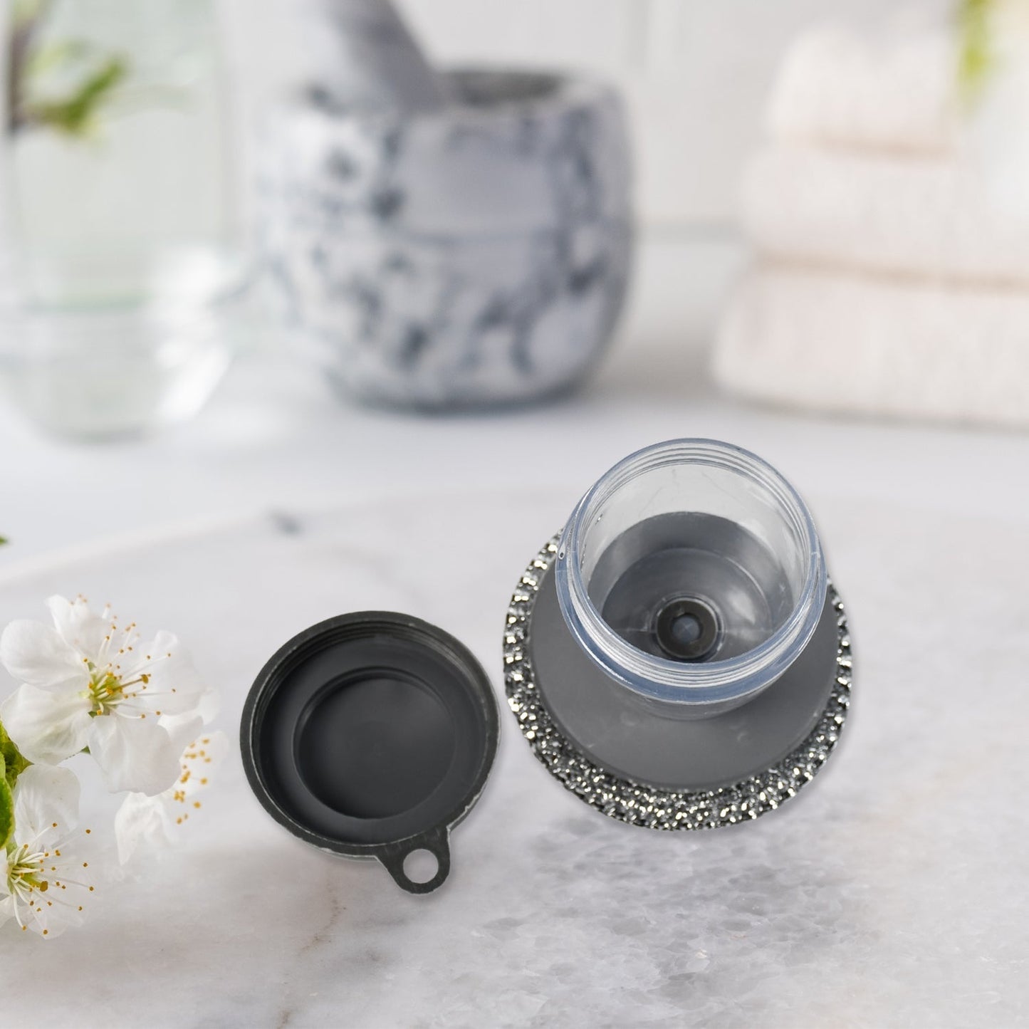 Compact kitchen cleaning brush with an integrated soap dispenser, ideal for small spaces.
