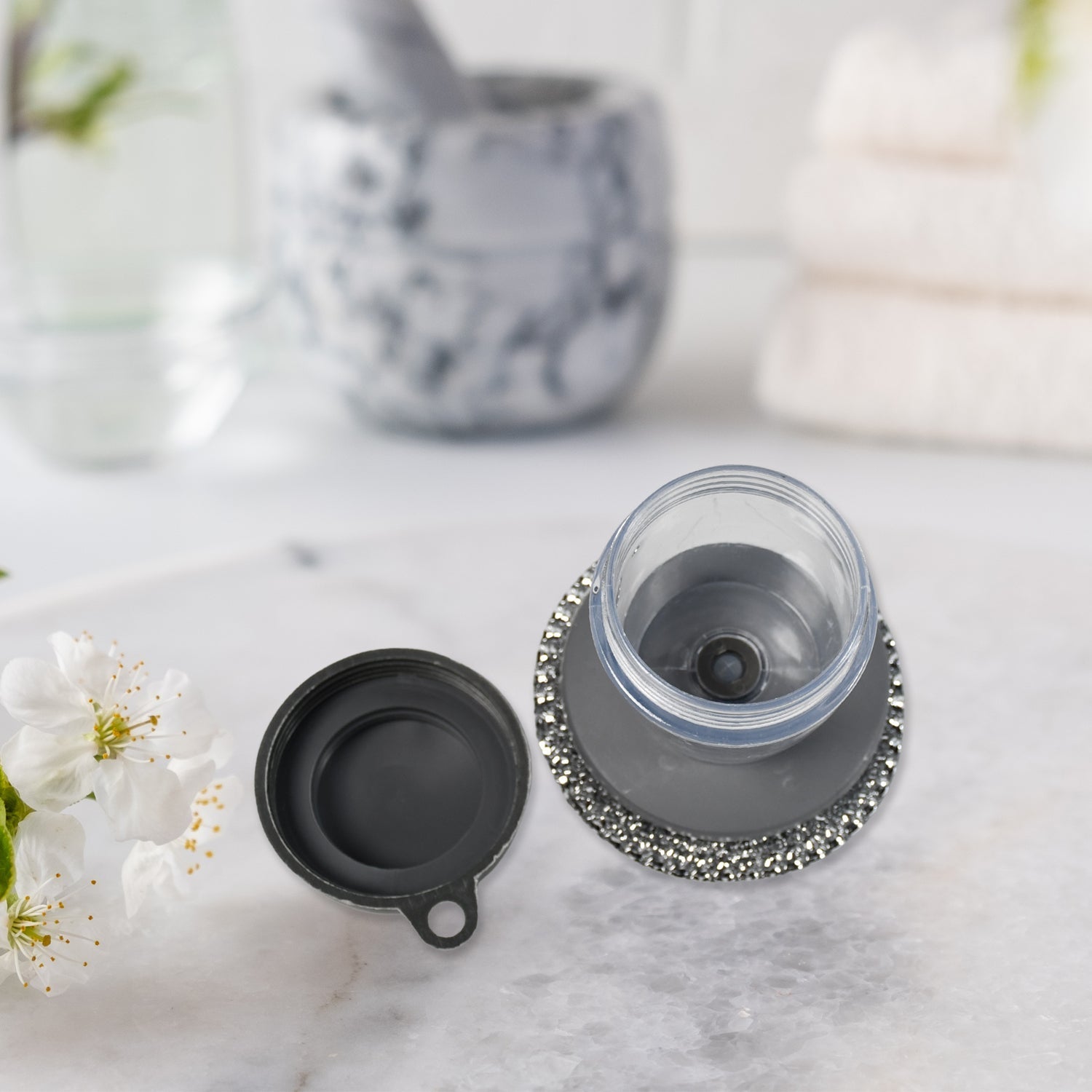 Compact kitchen cleaning brush with an integrated soap dispenser, ideal for small spaces.