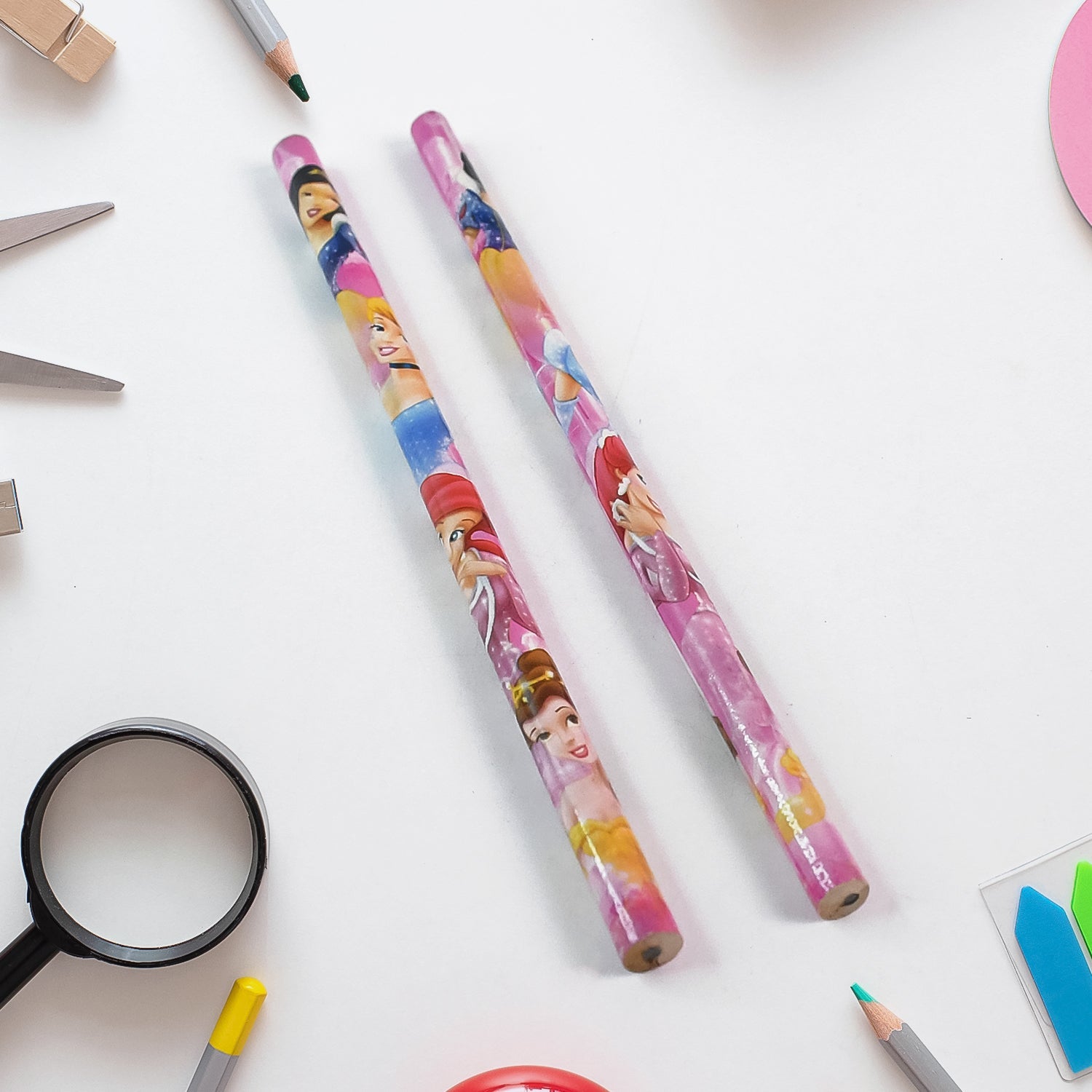 Detailed view of cartoon-themed wooden pencils and a matching sharpener.