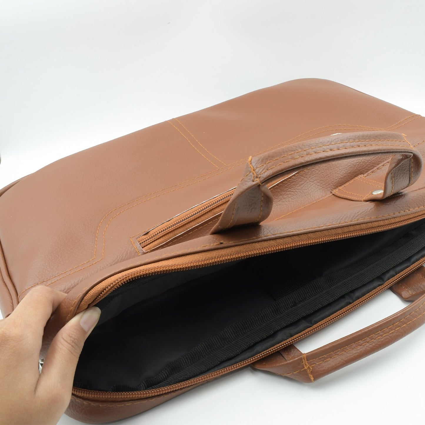 Close-up of the durable faux leather material and sturdy metal hardware on the bag.