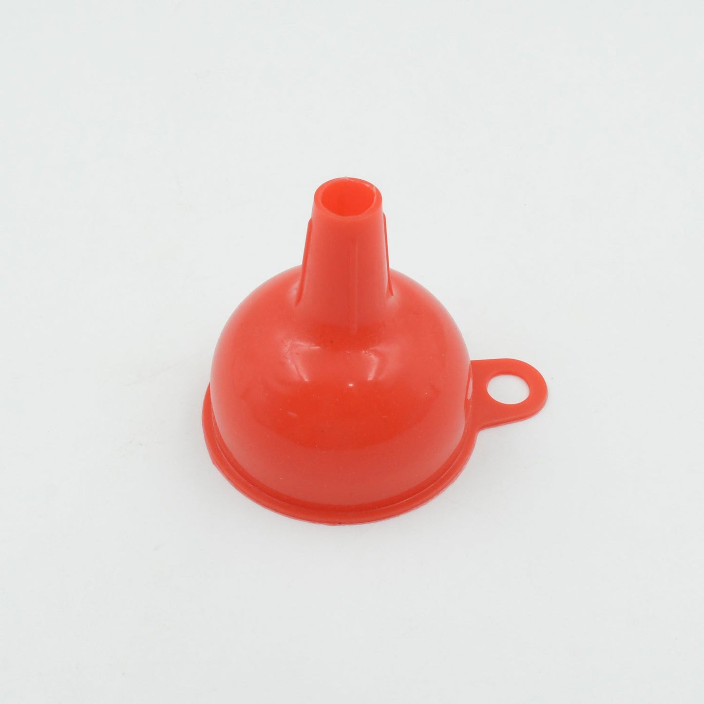Silicone funnel in action, efficiently pouring oil into a bottle.