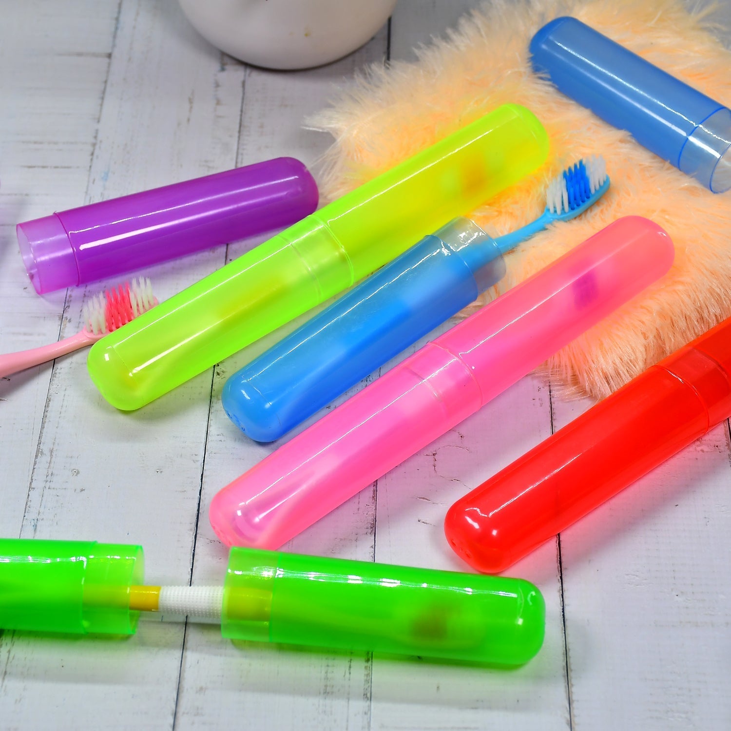 Six clear plastic travel toothbrush covers neatly stacked for hygienic storage.