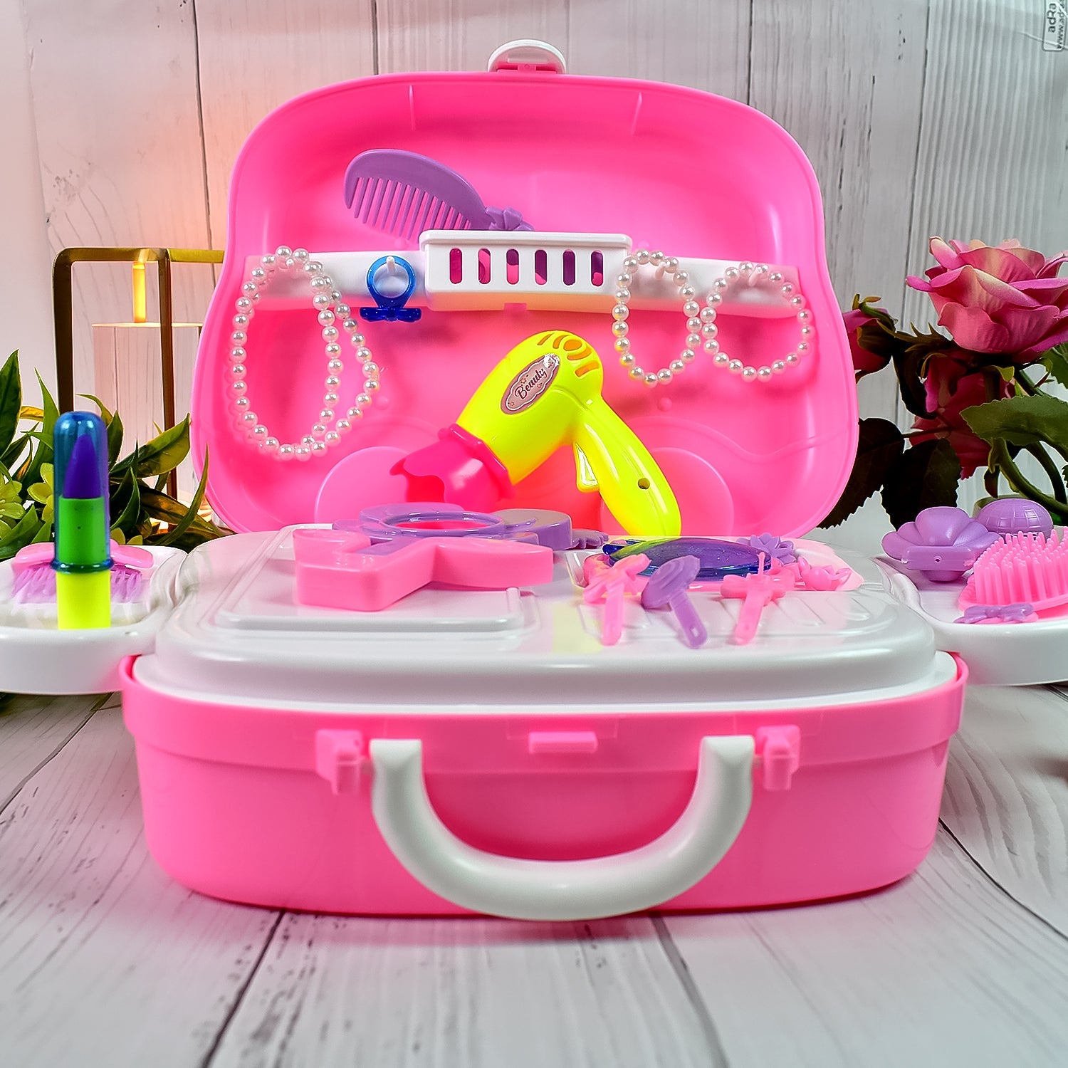Child holding an open pretend makeup case, ready for play.