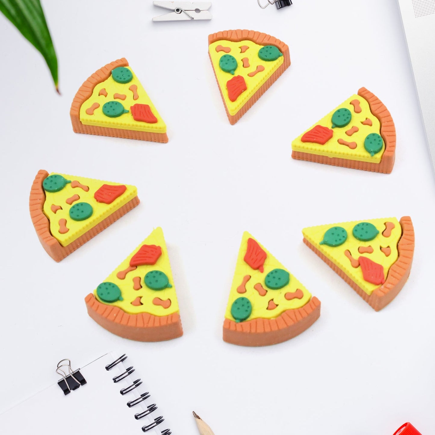 Three 3D pizza slice erasers stacked together, highlighting their playful design.