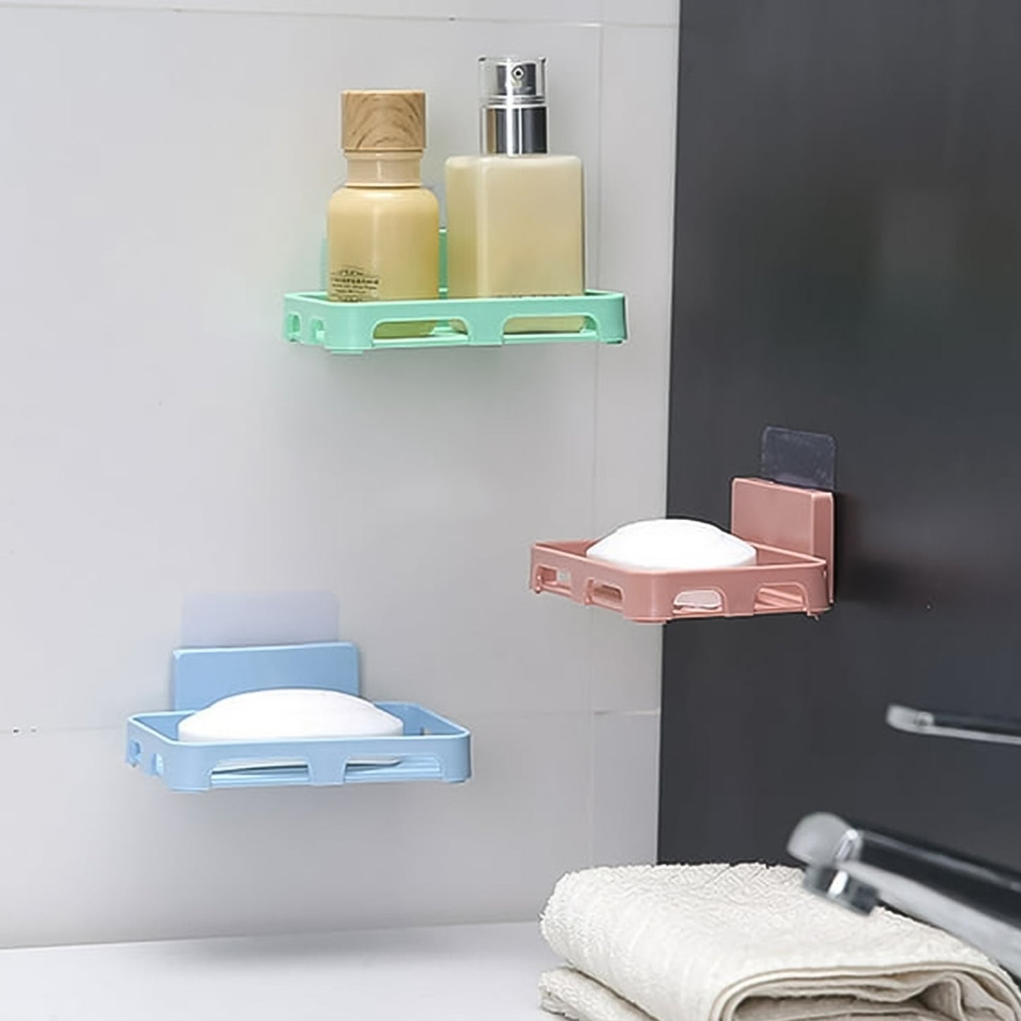 Self-adhesive wall-mounted soap holder installed in a shower for easy access to soap.