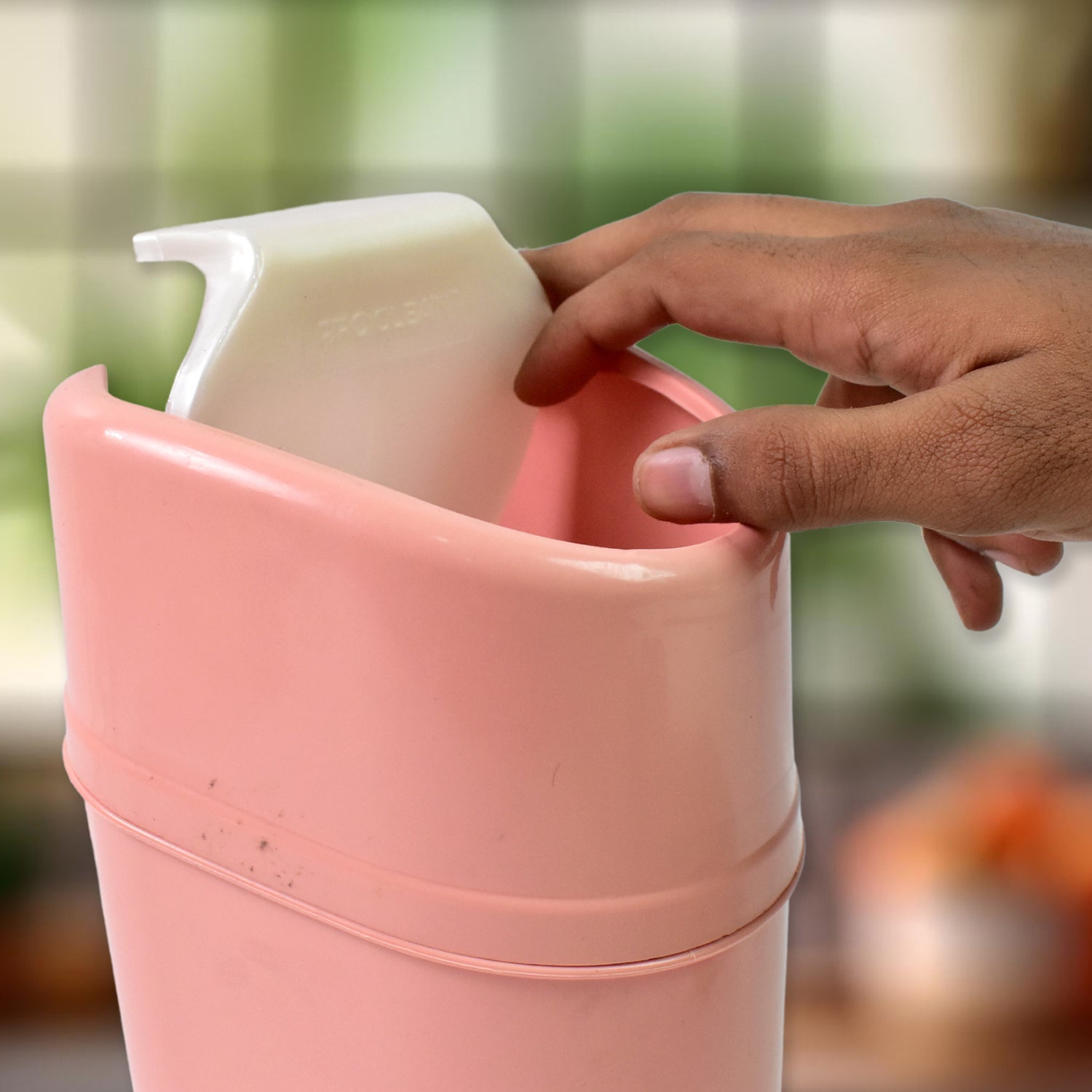 Mini dustbin with its swing lid open, revealing the interior for easy waste disposal.