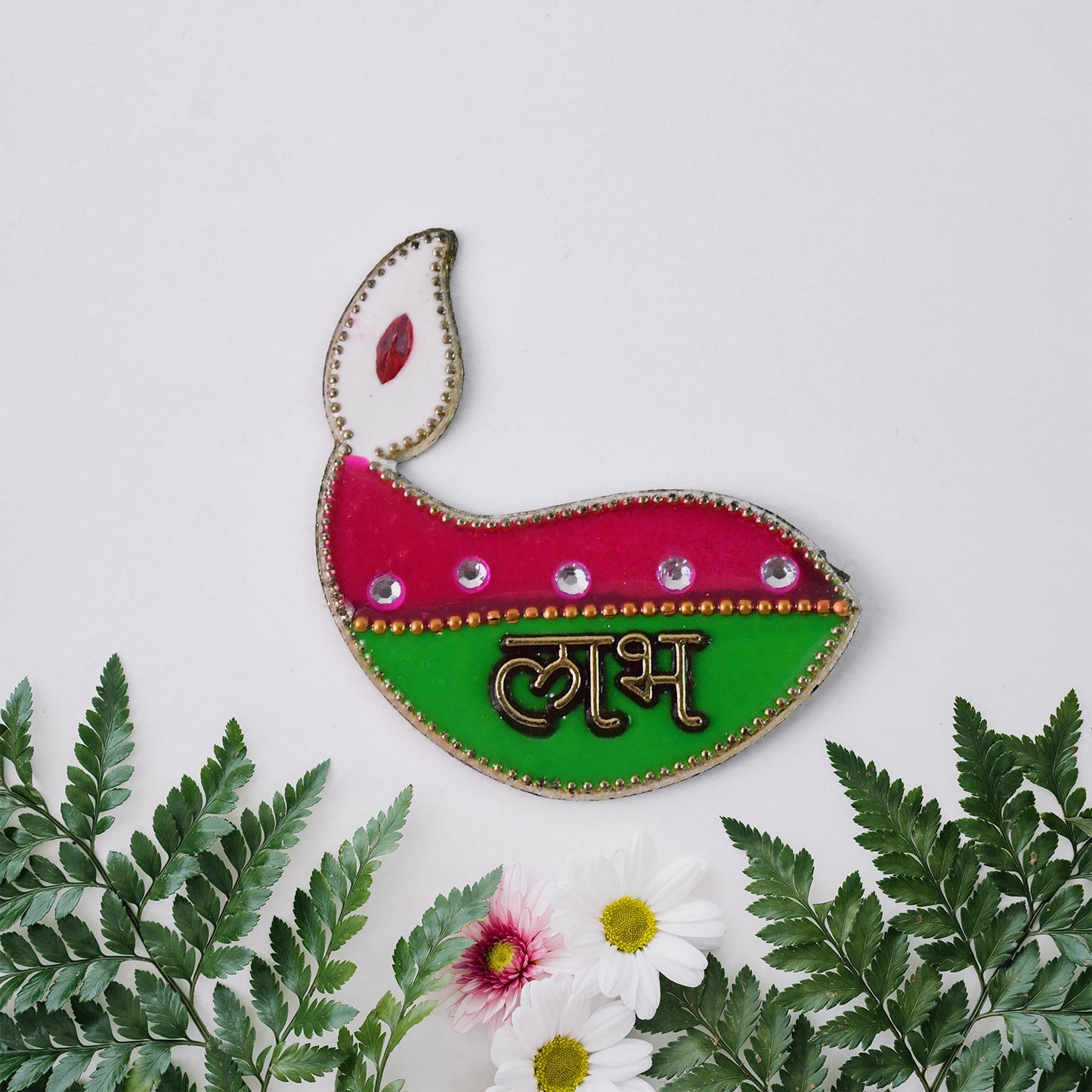 Close-up of diya shaped Shubh Labh wall hangings with golden borders and vibrant colors