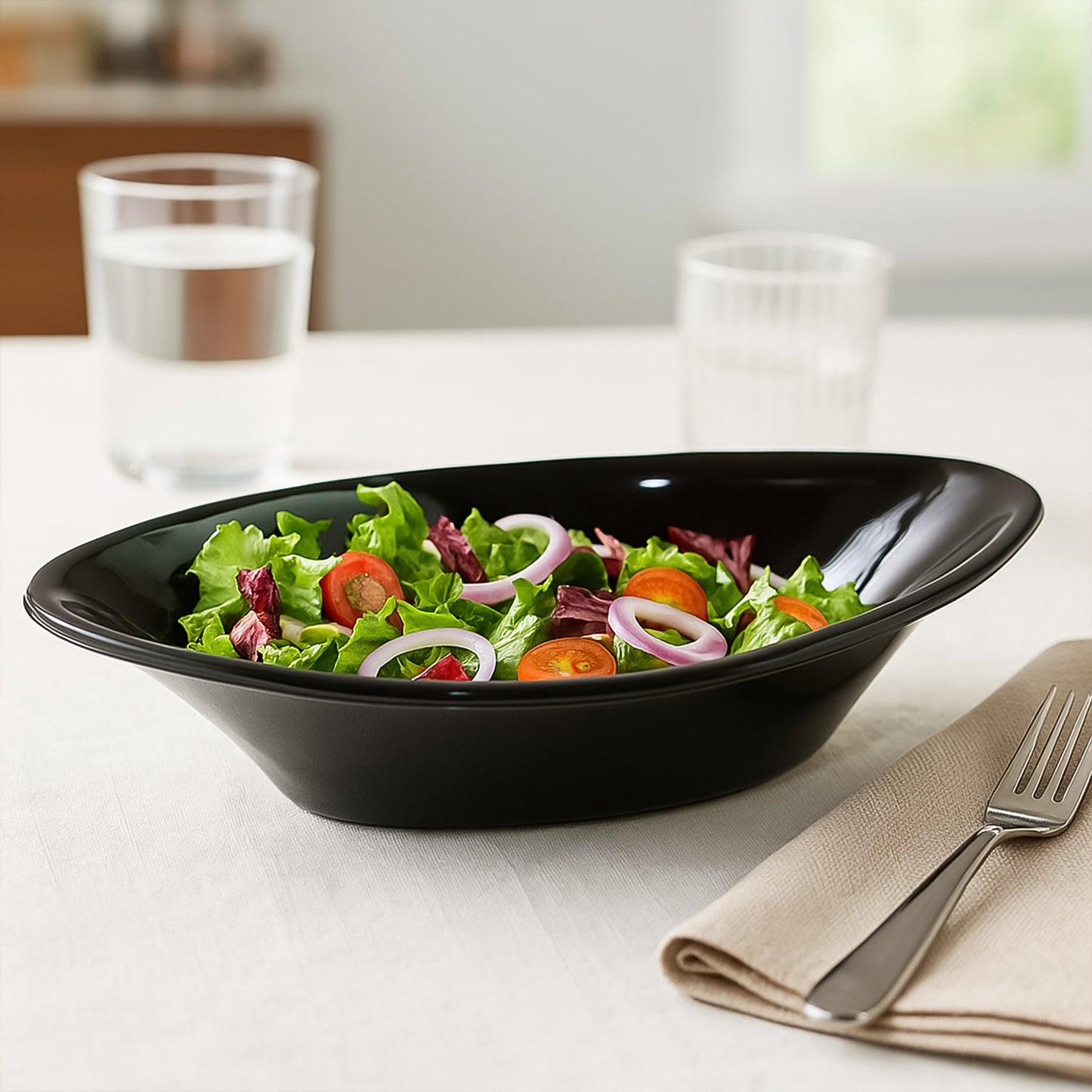 Side view of black plastic Marin serving bowl showcasing depth and oval design