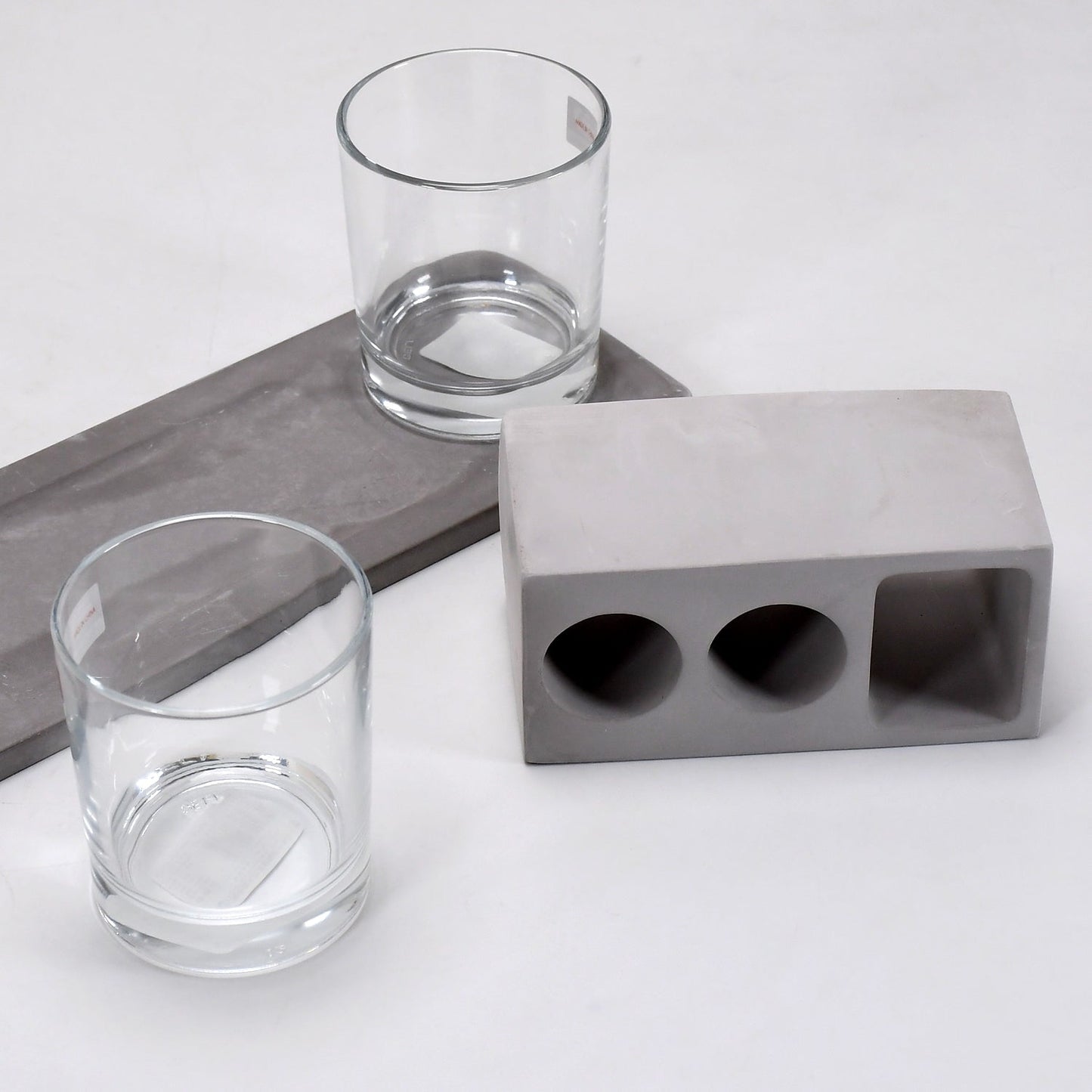 Elegant wine glass holder set with two glasses on a marble base, ideal for home decor.