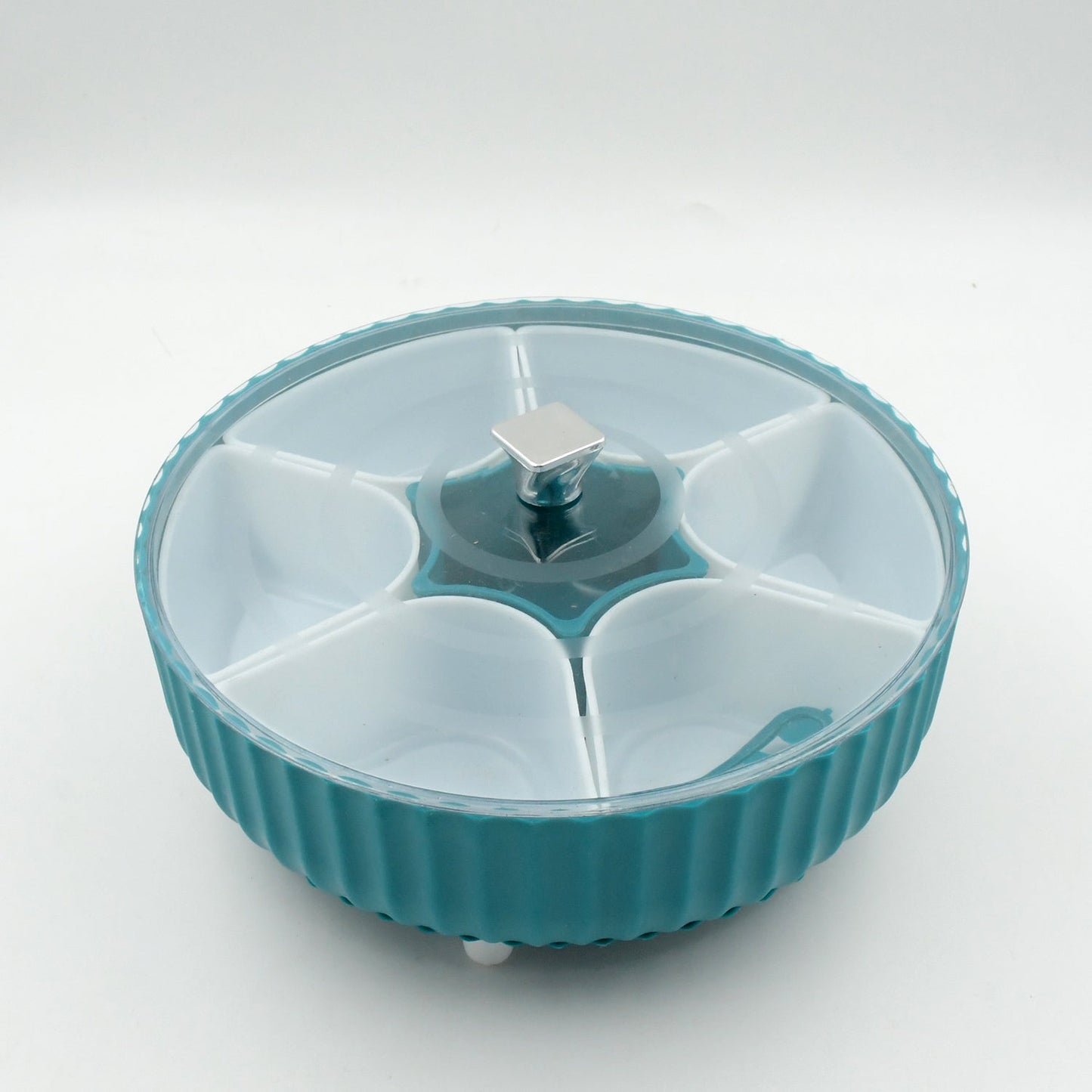 Top-down view of the revolving container filled with various dry fruits.