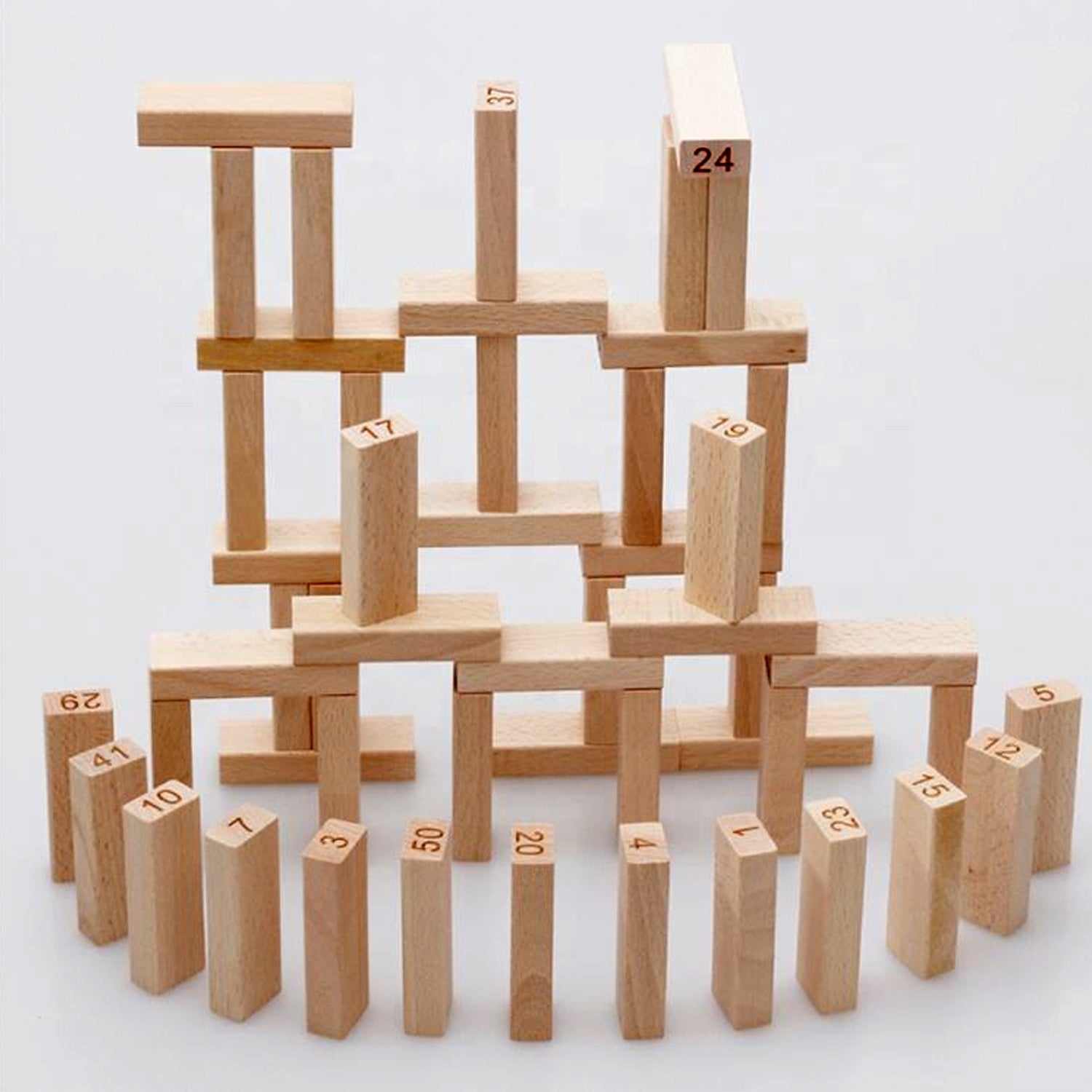 A player carefully removing a wooden block from the mid-section of the tall tumbling tower.
