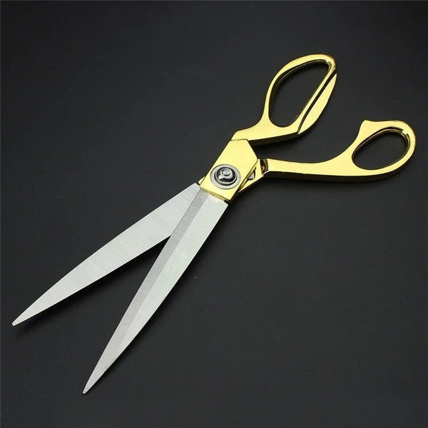 Golden handle cloth cutting scissors with sharp blades.