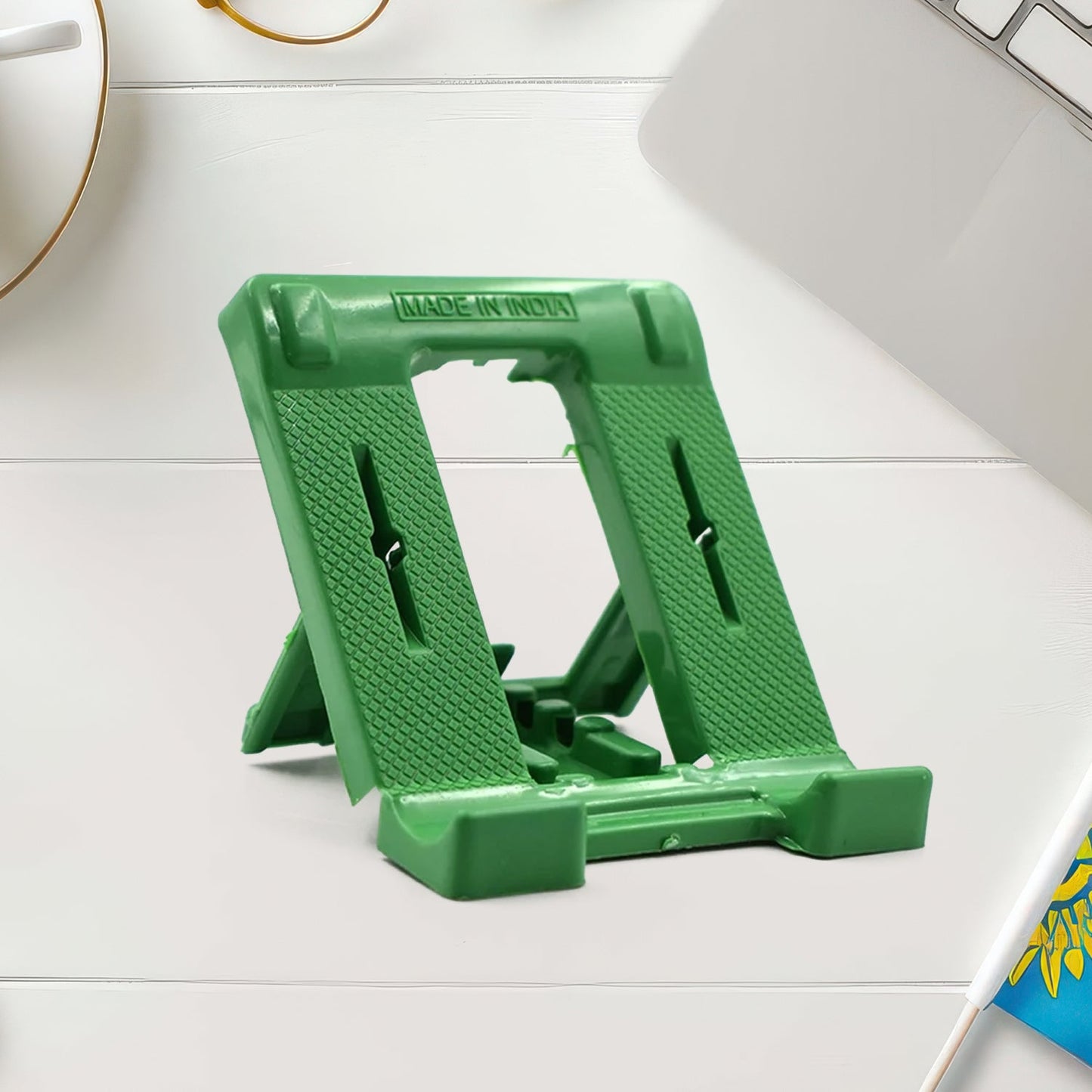 Foldable phone stand holding smartphone horizontally with adjustable angle