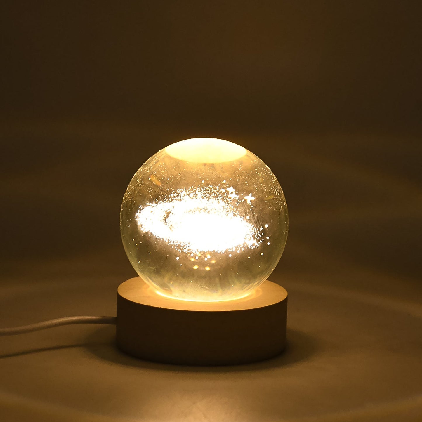 3D Crystal Ball Lamp emitting warm light on a desk, perfect as ambient lighting.