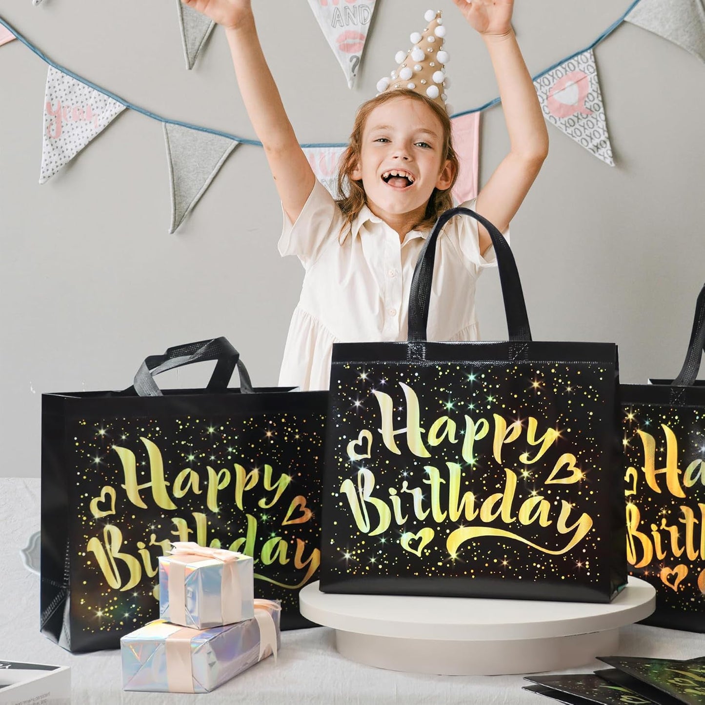 Black birthday gift bag featuring gold star pattern for party gifts