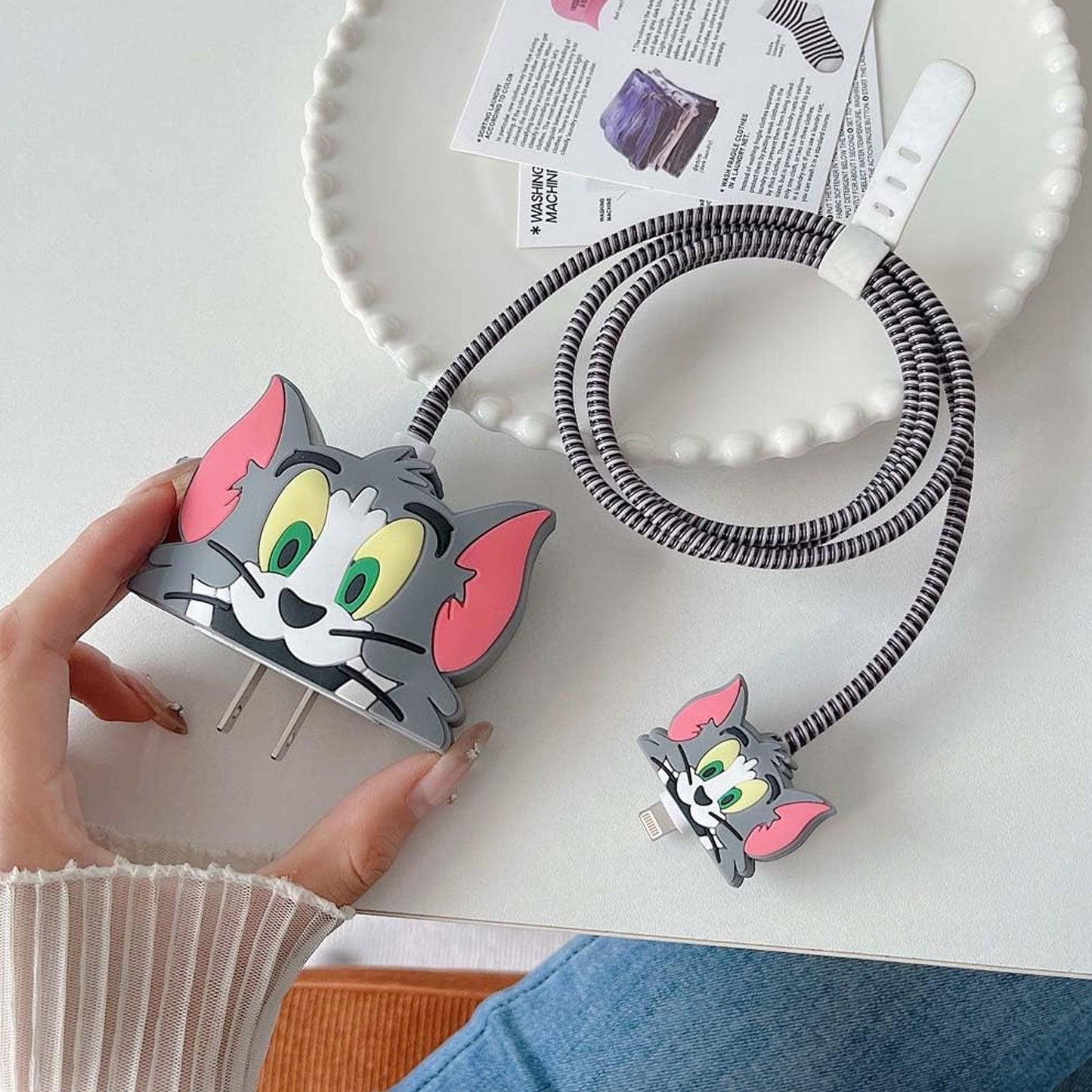 The cute cartoon charger cover fitted perfectly on an iPhone 18-20W power adapter.