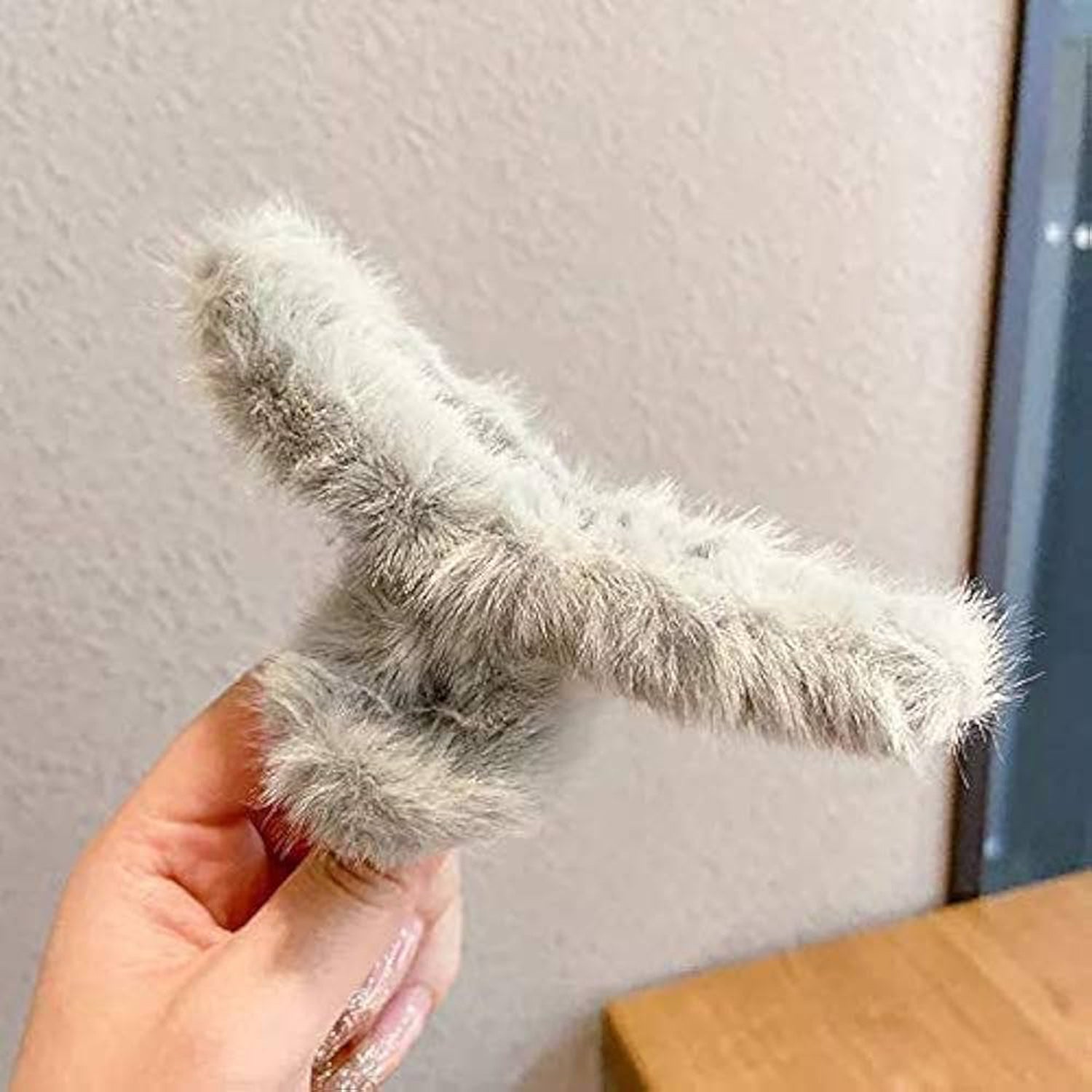 Soft plush hair accessory, a large claw clip in a muted tone, ideal for everyday elegance.