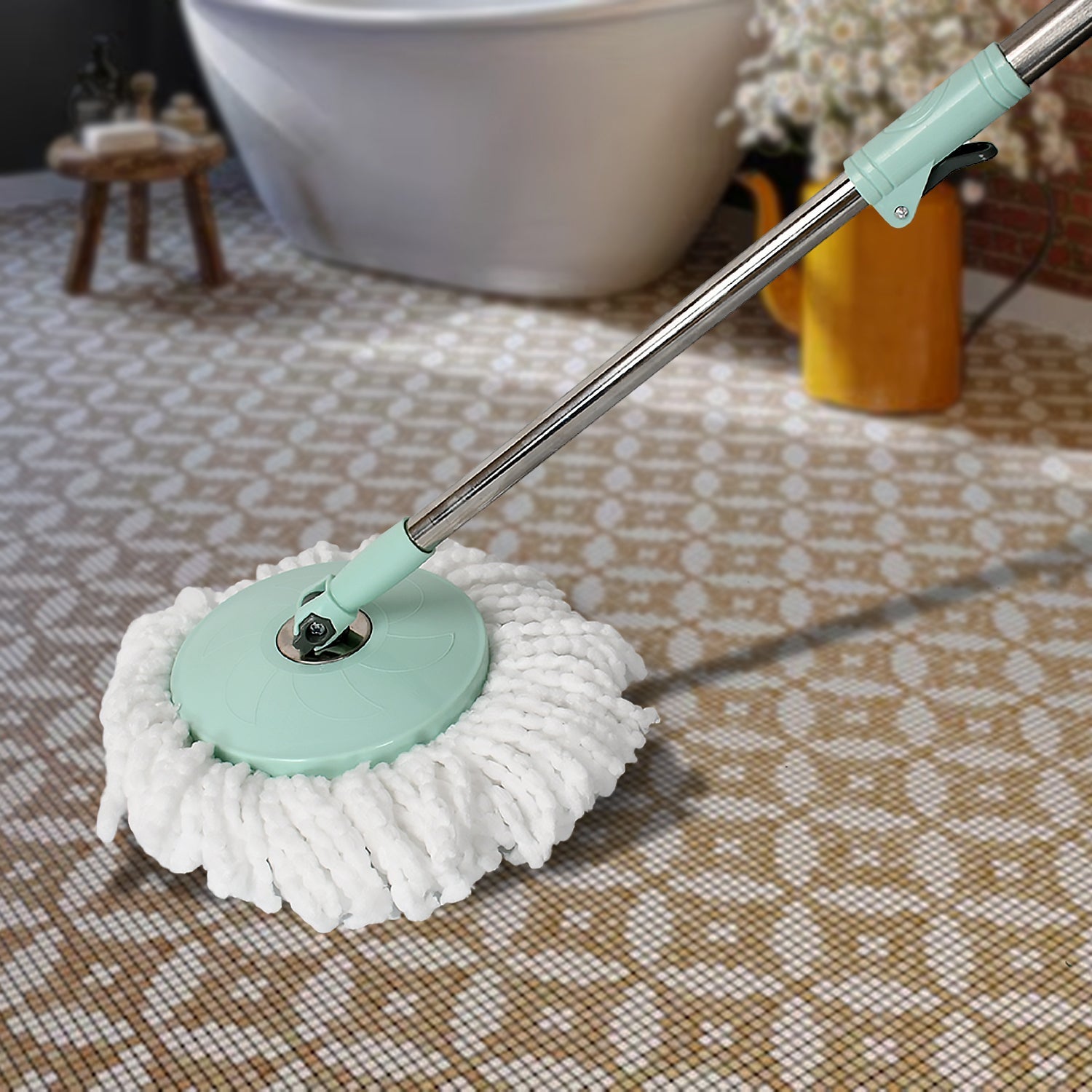 The Ganesh Spin Mop with Bucket shown in action, cleaning a floor with its 360-degree rotating head.