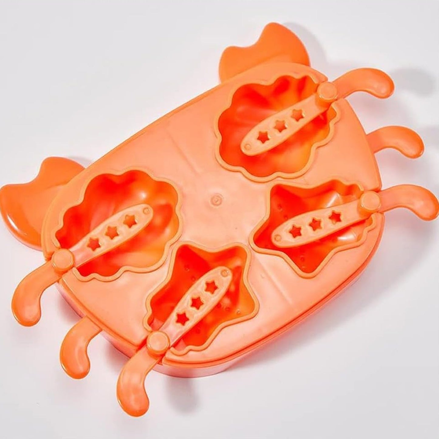 The crab-shaped ice mold filled with liquid, ready for freezing.