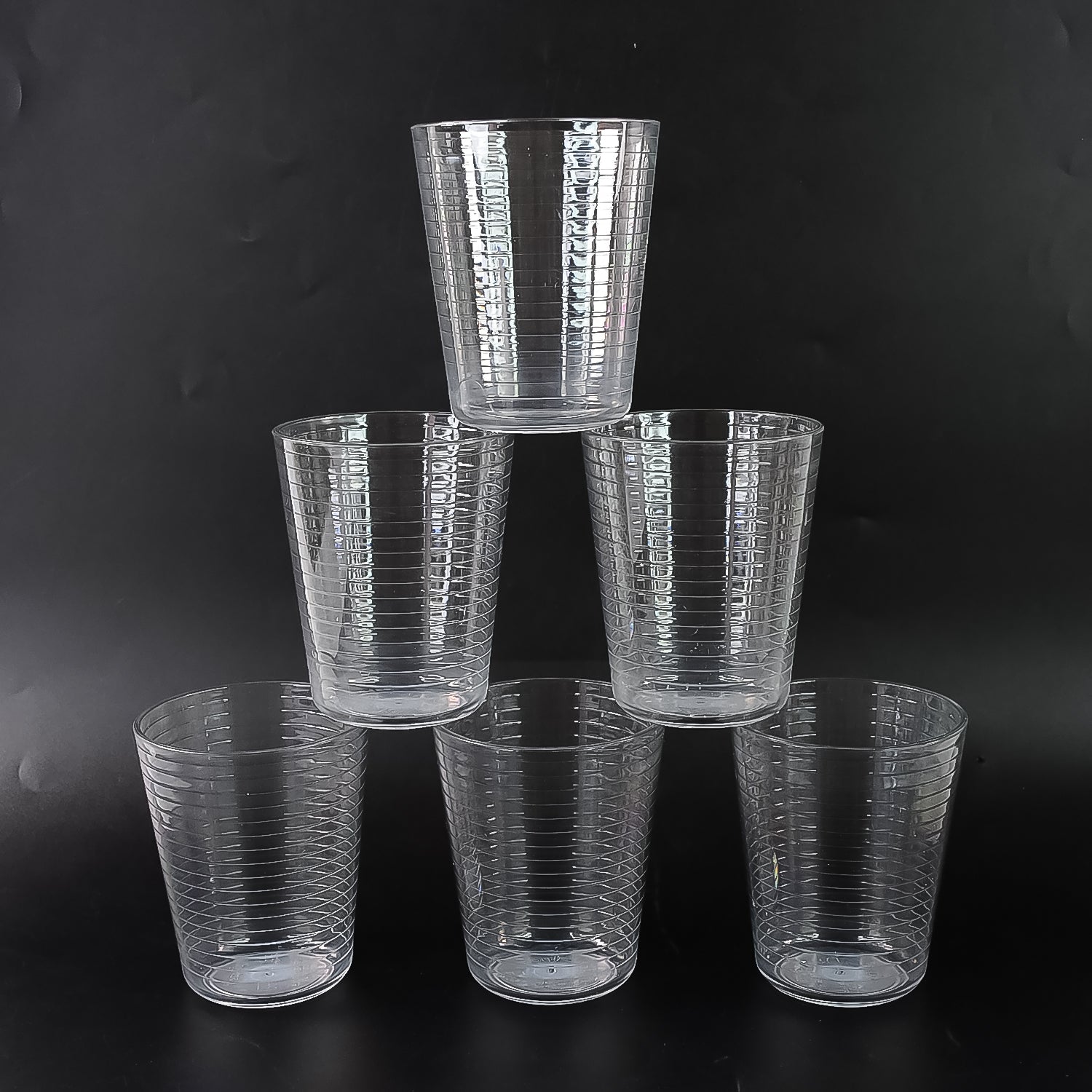 Crystal-clear Plastic Ringo Glass filled with chilled beverage on table