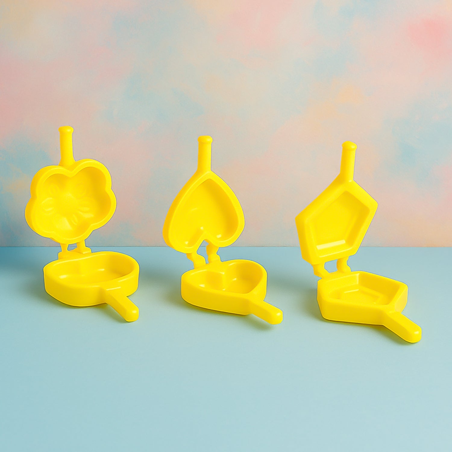 Plastic cookie cutters arranged on kitchen counter for biscuit making