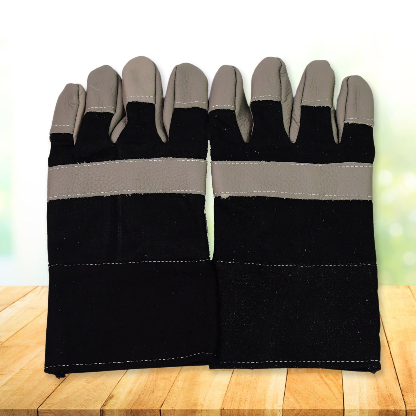 Heavy-duty gardening gloves protecting hands from thorny bushes.