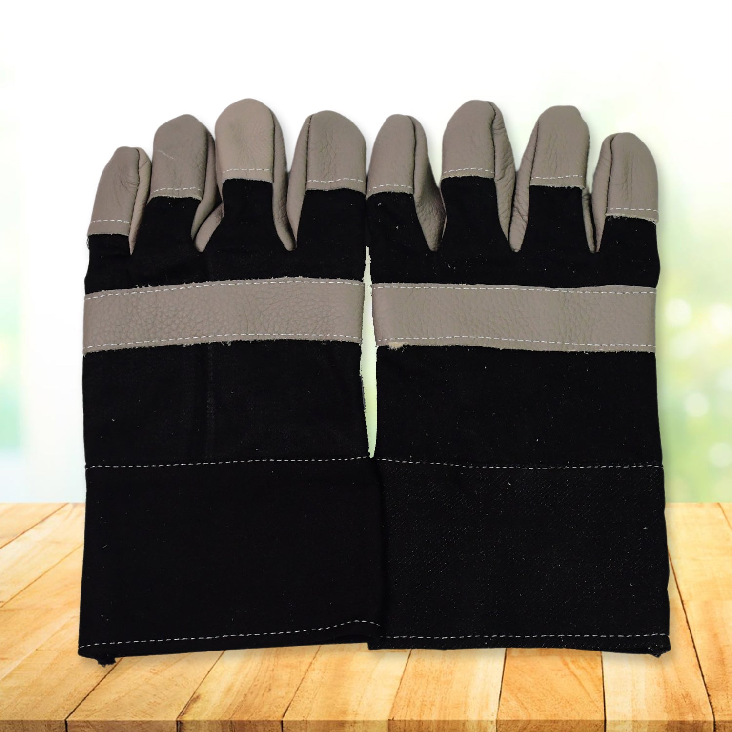 Heavy-duty gardening gloves protecting hands from thorny bushes.