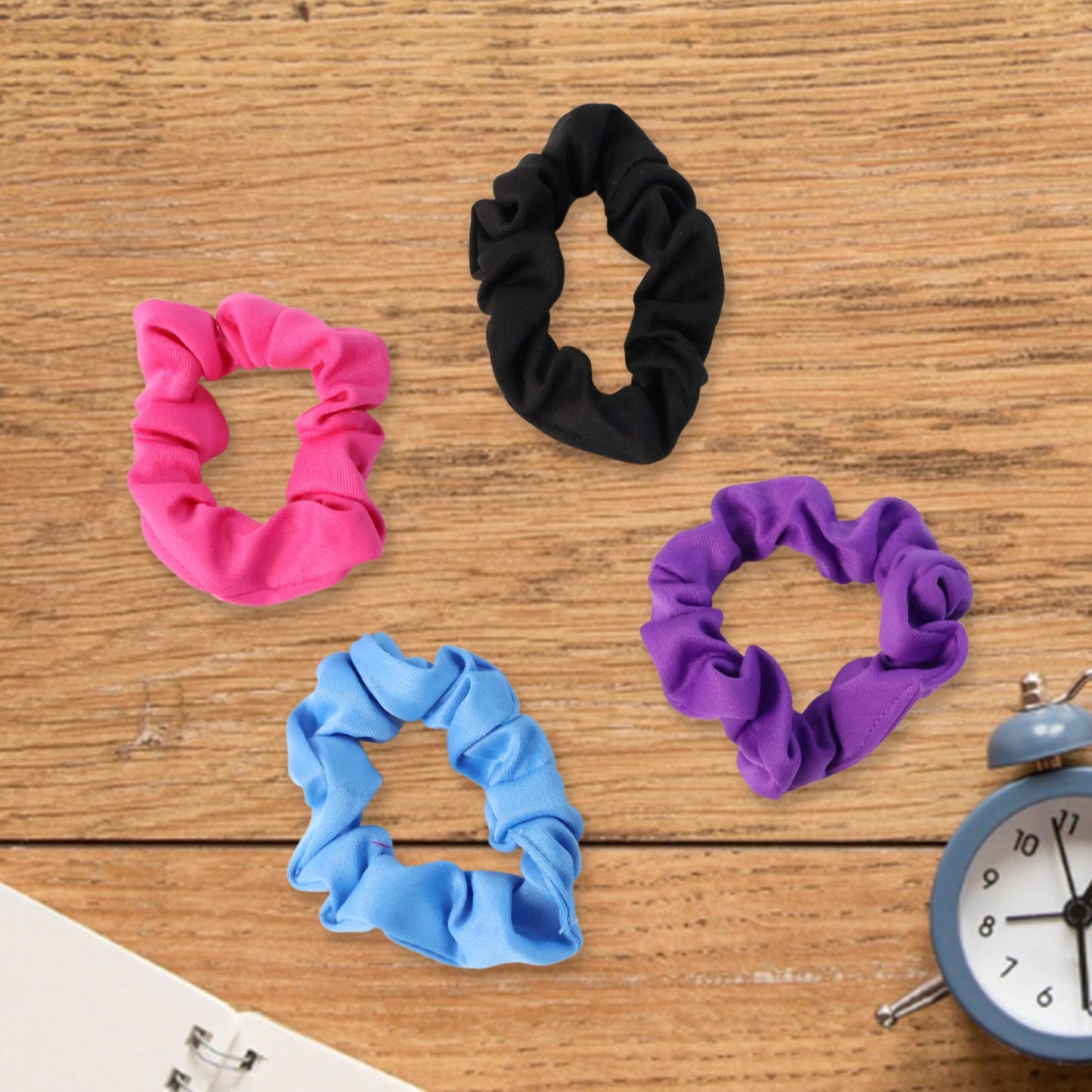 A soft hair scrunchie tied neatly around a hair bun, demonstrating a secure and comfortable hold.