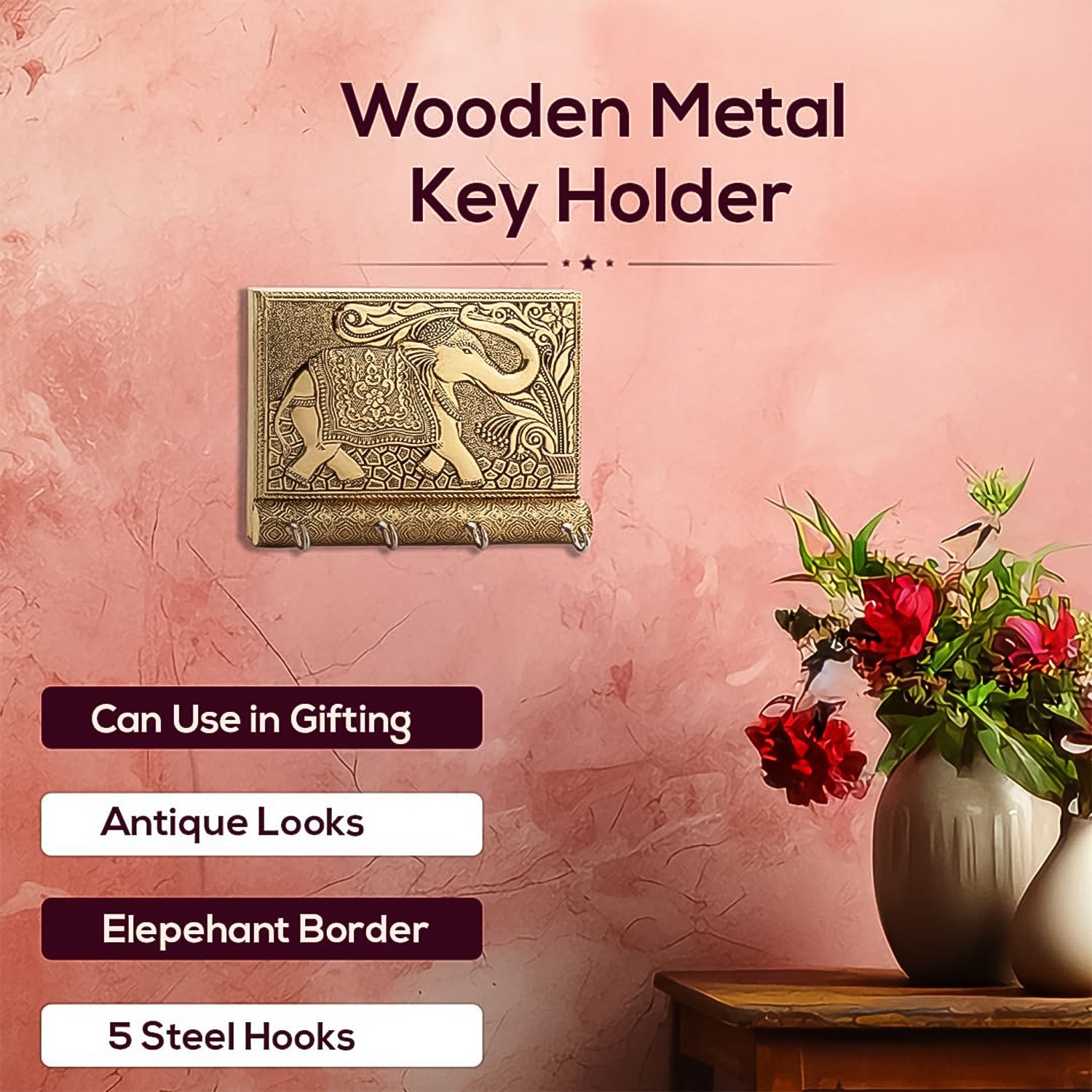 Front view of the wooden elephant key holder featuring four gold metal hooks.