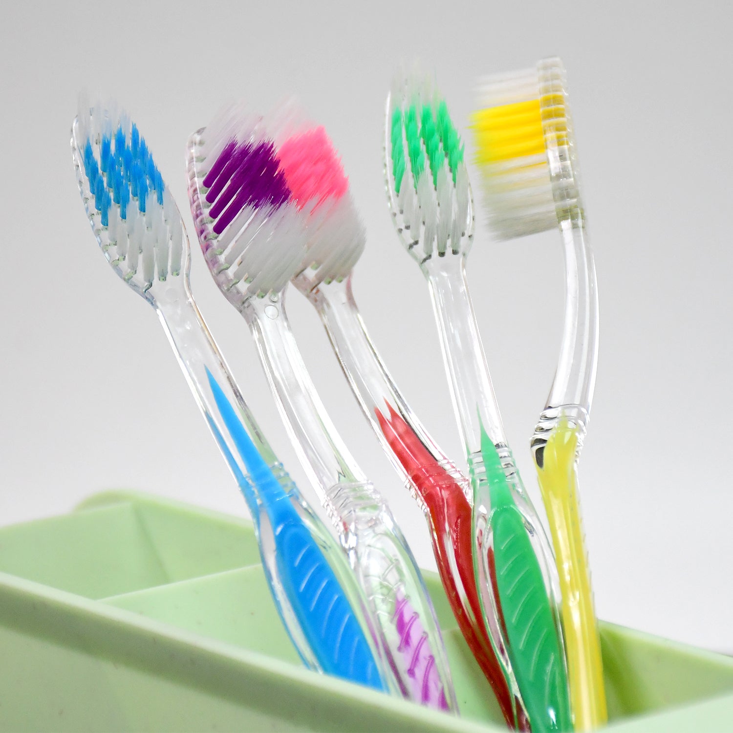 Side view of a MintGuard premium plastic toothbrush, showcasing its sleek design.
