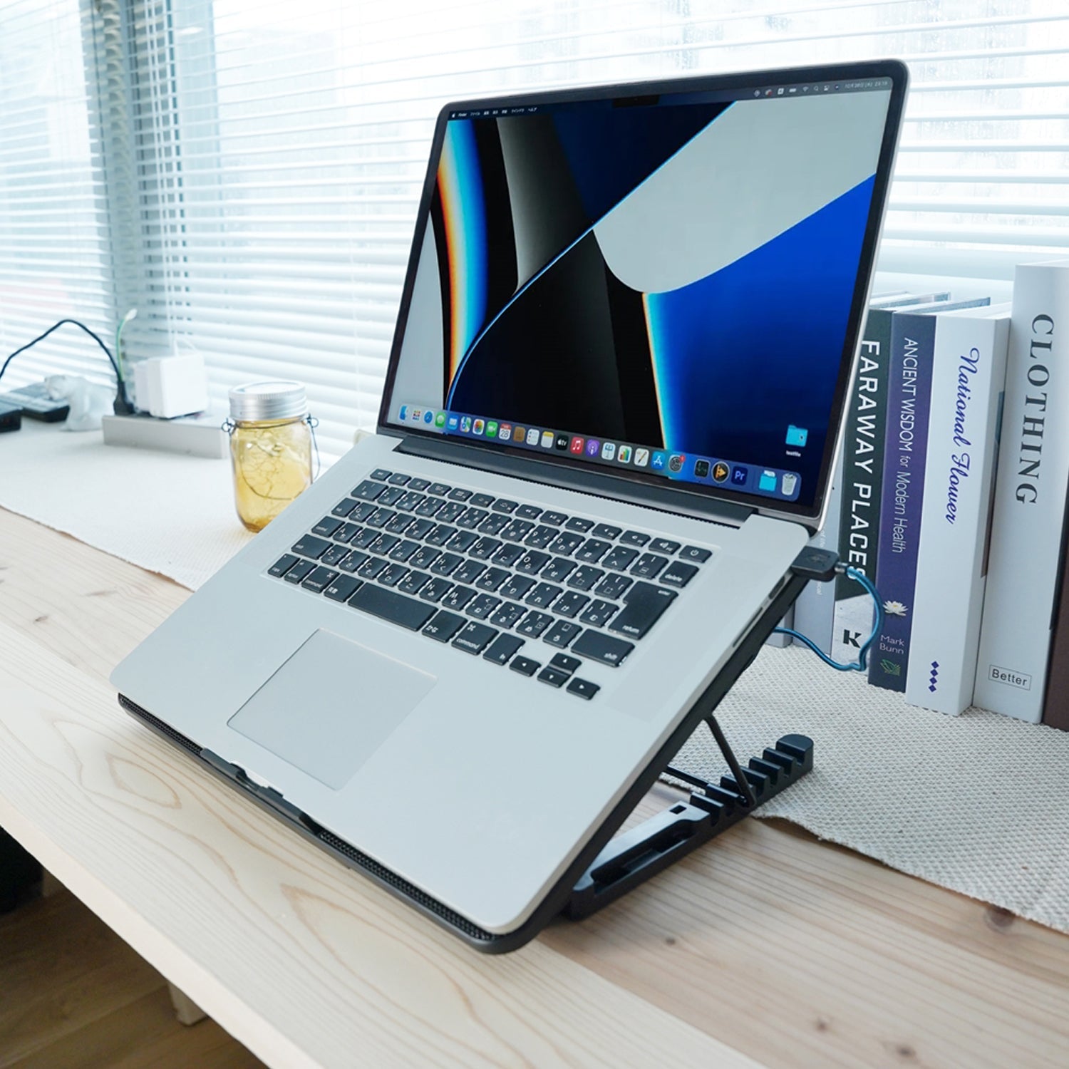 Laptop cooling pad with a gaming laptop placed on top, showing effective cooling in use.