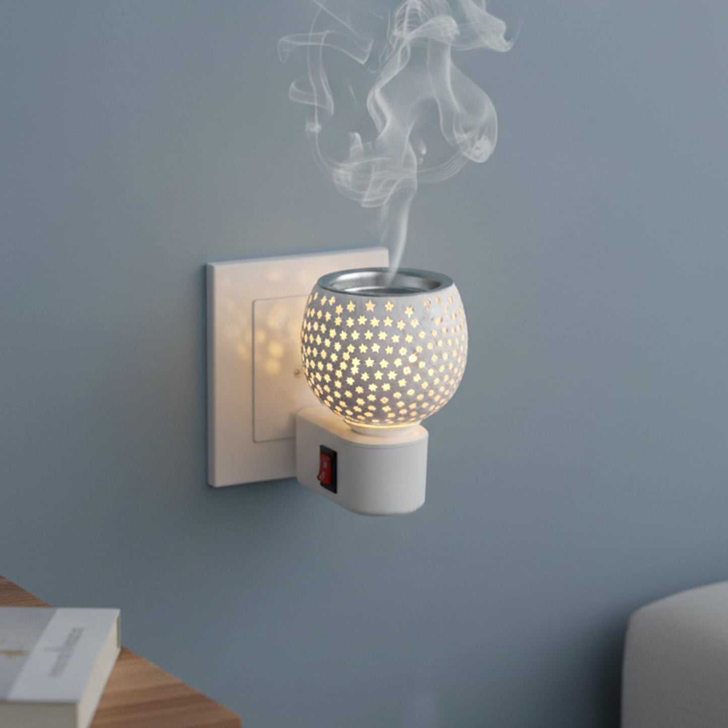 Star cut glass aroma diffuser plugged into electrical wall socket
