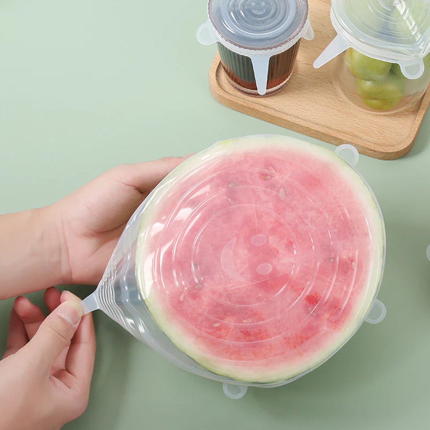 Reusable silicone food covers being used on kitchen containers