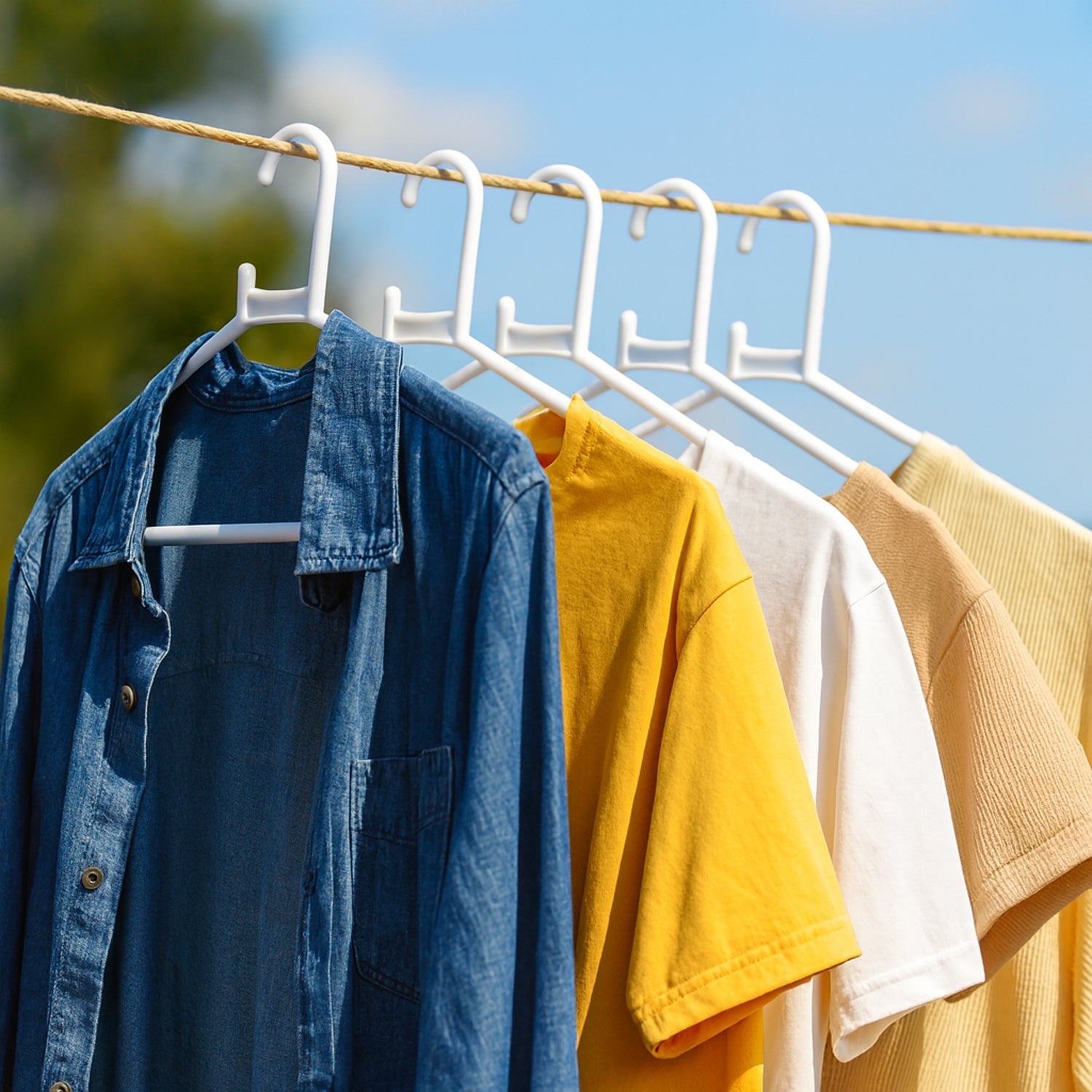 White plastic clothes hanger in practical use inside a closet