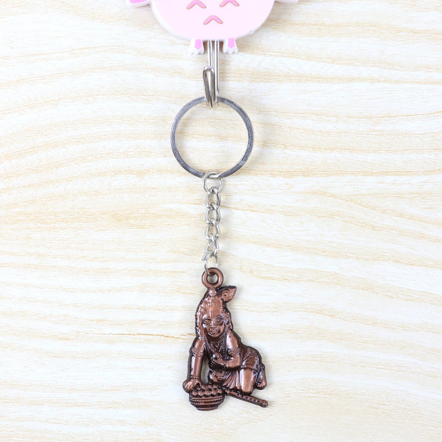 Metal Bal Krishna keychain attached to a set of keys