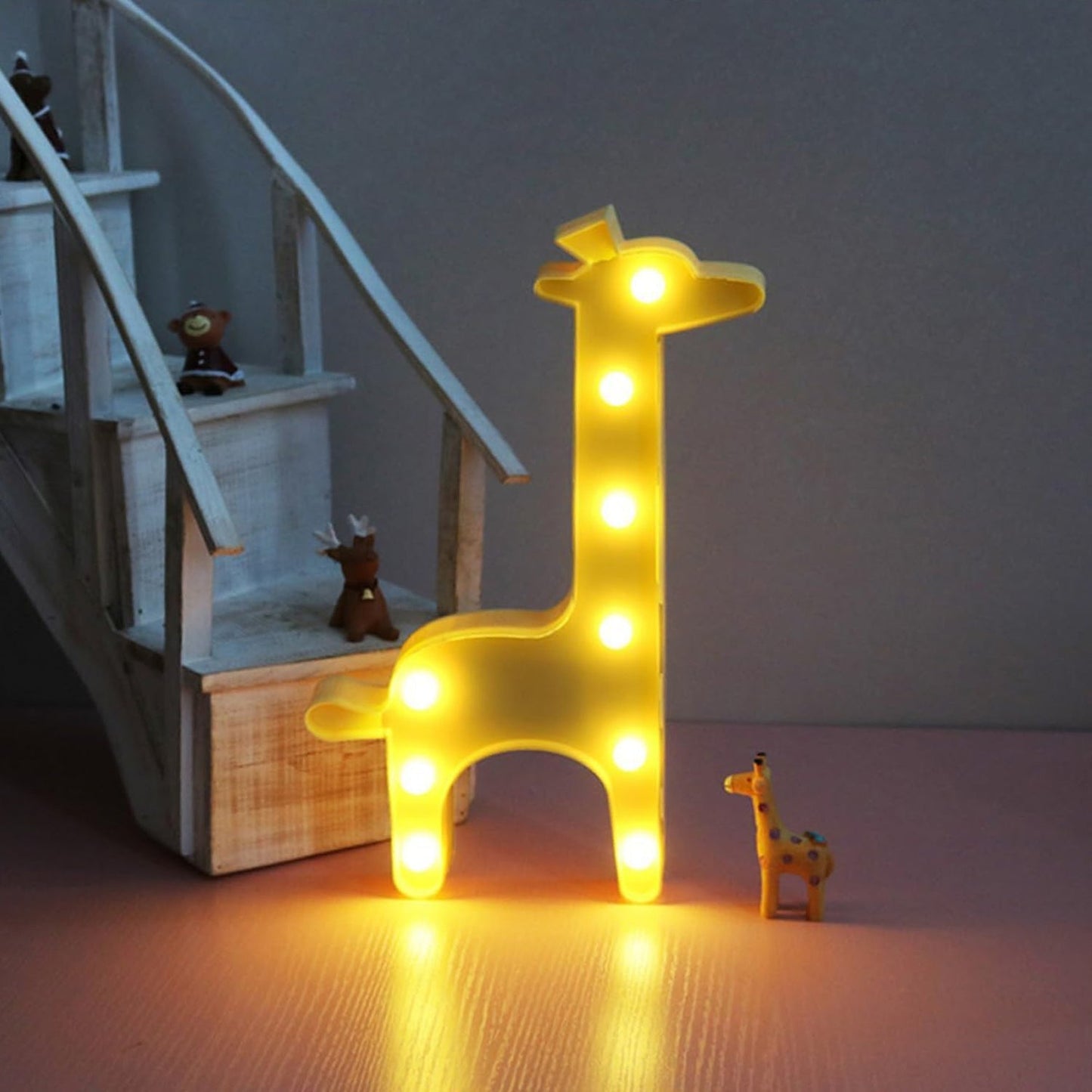 Portable giraffe LED decorative light glowing softly in children's room