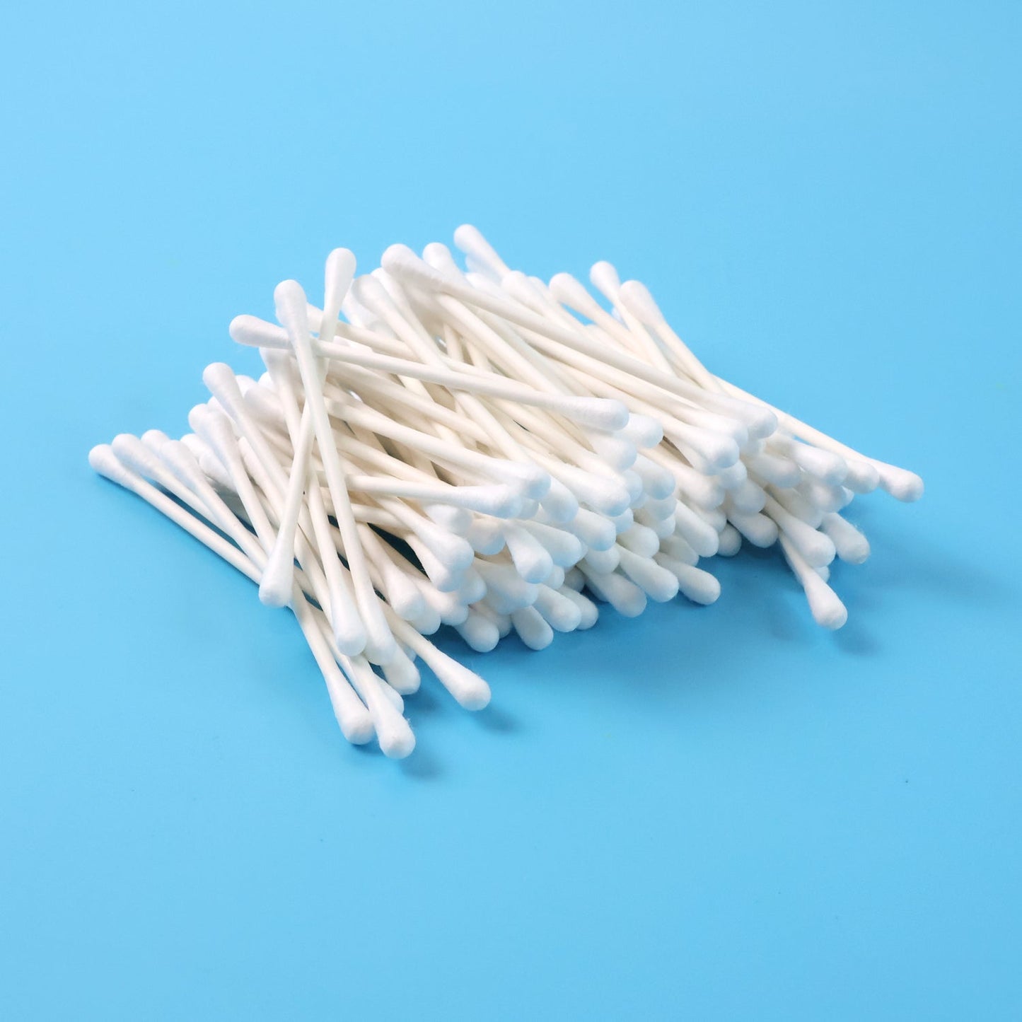 Close-up of cotton swabs highlighting paper stick stems for grooming