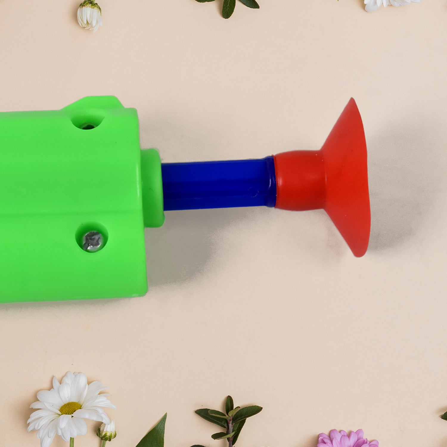 Child's hand holding the toy gun, illustrating how to shoot soft darts safely.