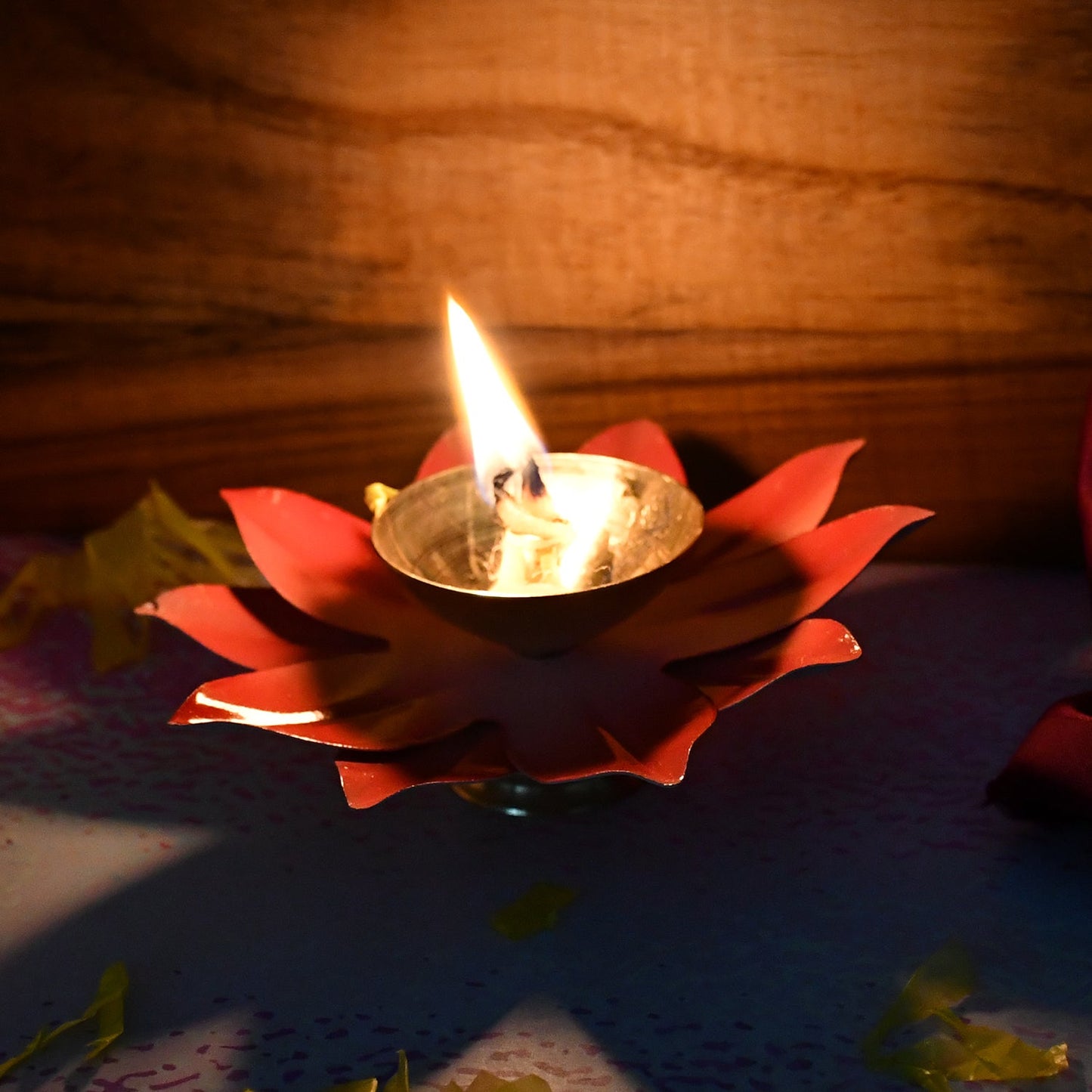 Side view of brass oil diya lotus shaped for pooja rituals