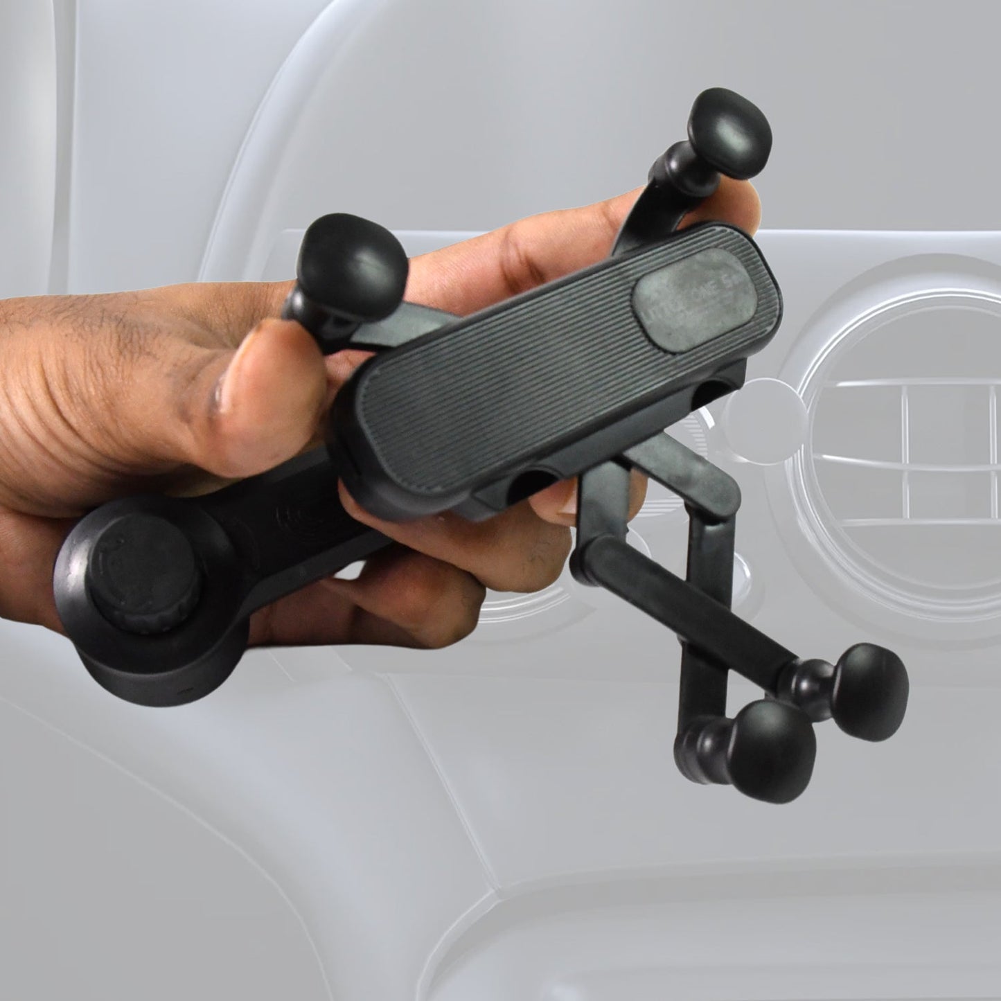 Detail view of the car phone holder's secure grip and soft padding protecting the phone.