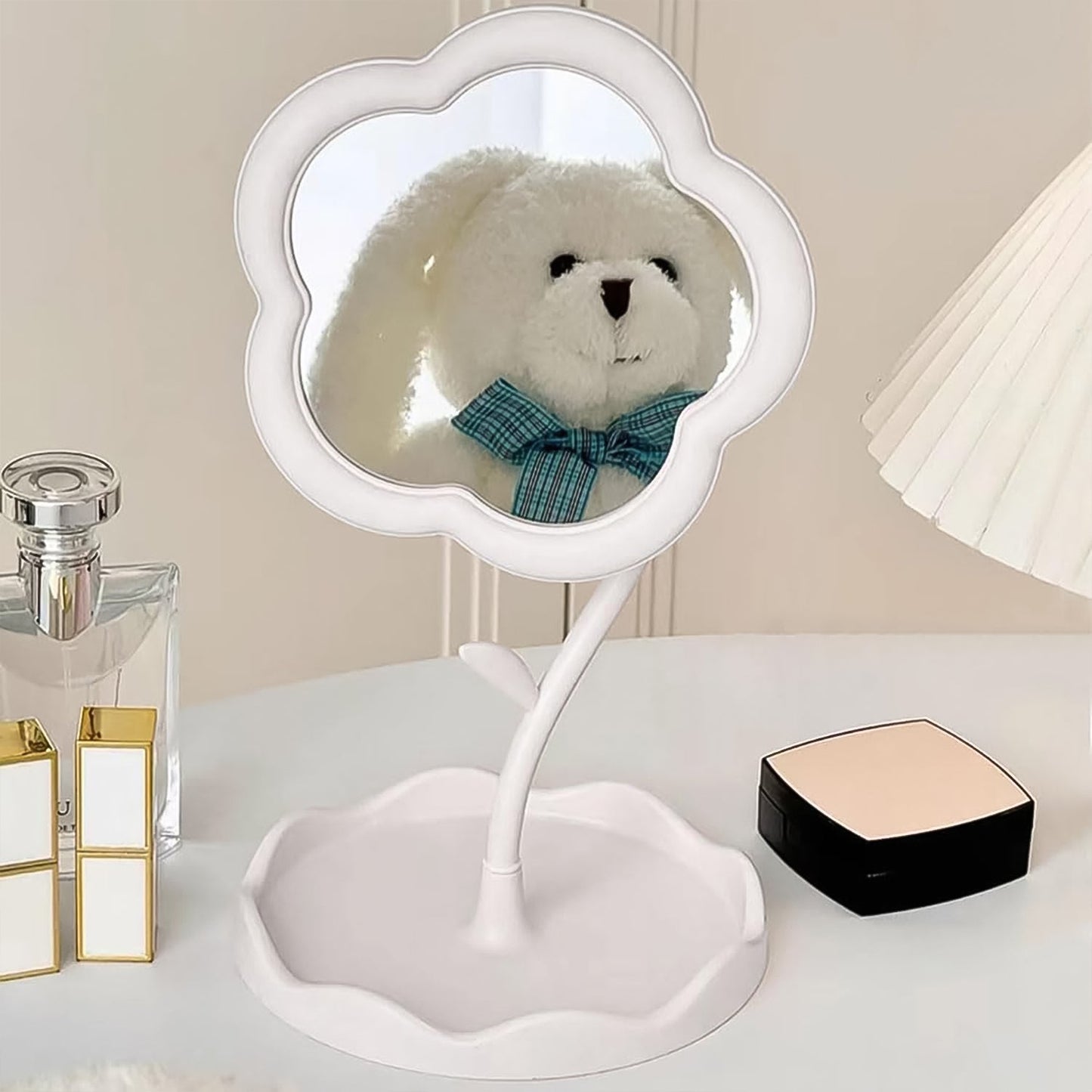 Hand adjusting the angle of the rotatable flower makeup mirror