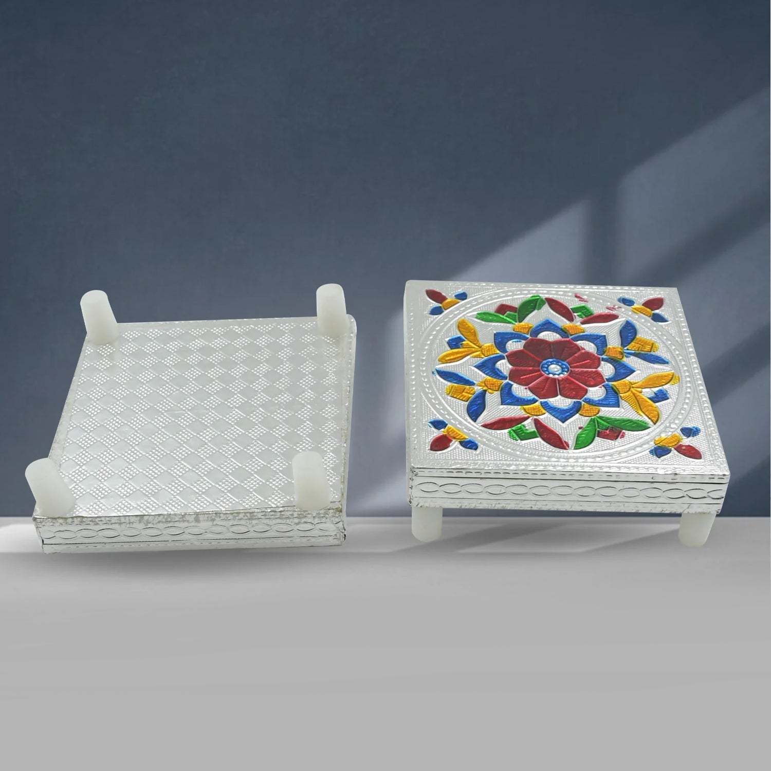 Top view of the Meenakari chowki with a small diya and puja items, ready for worship.