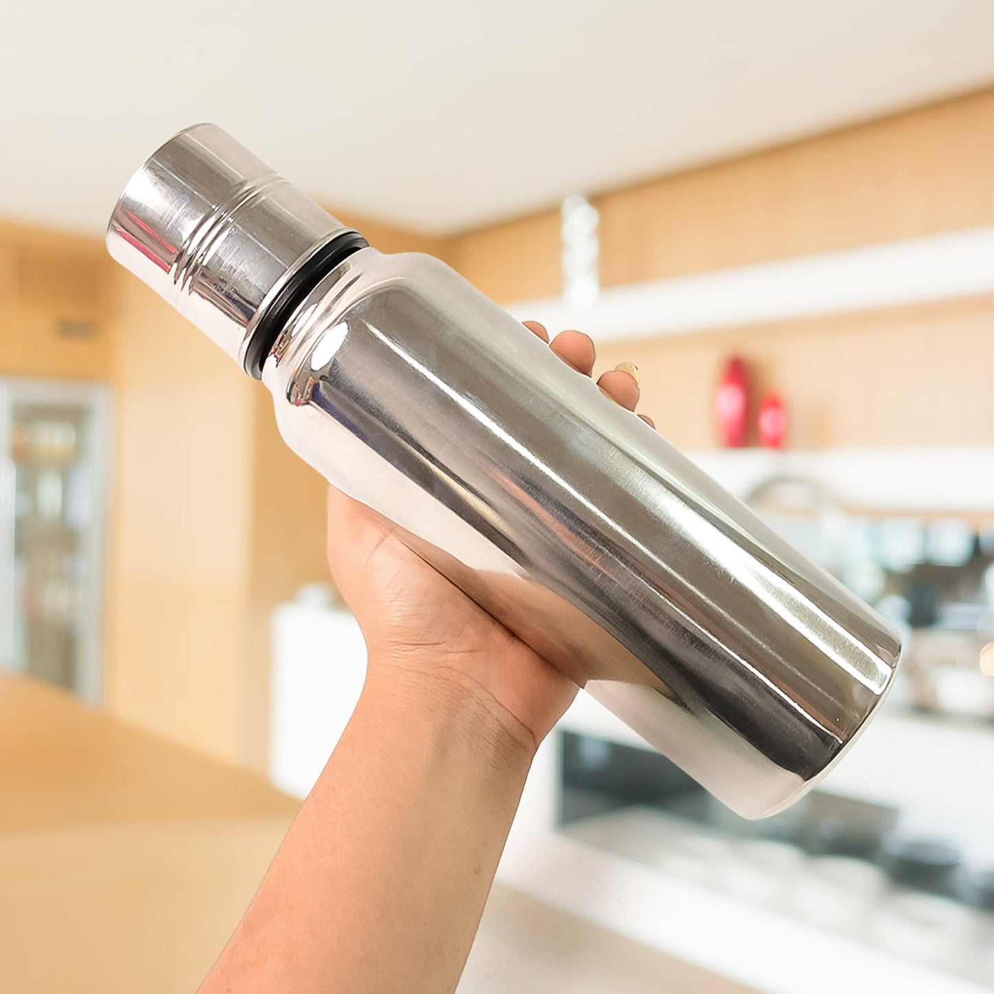 Close-up top view of stainless steel oil pourer showing wide mouth opening