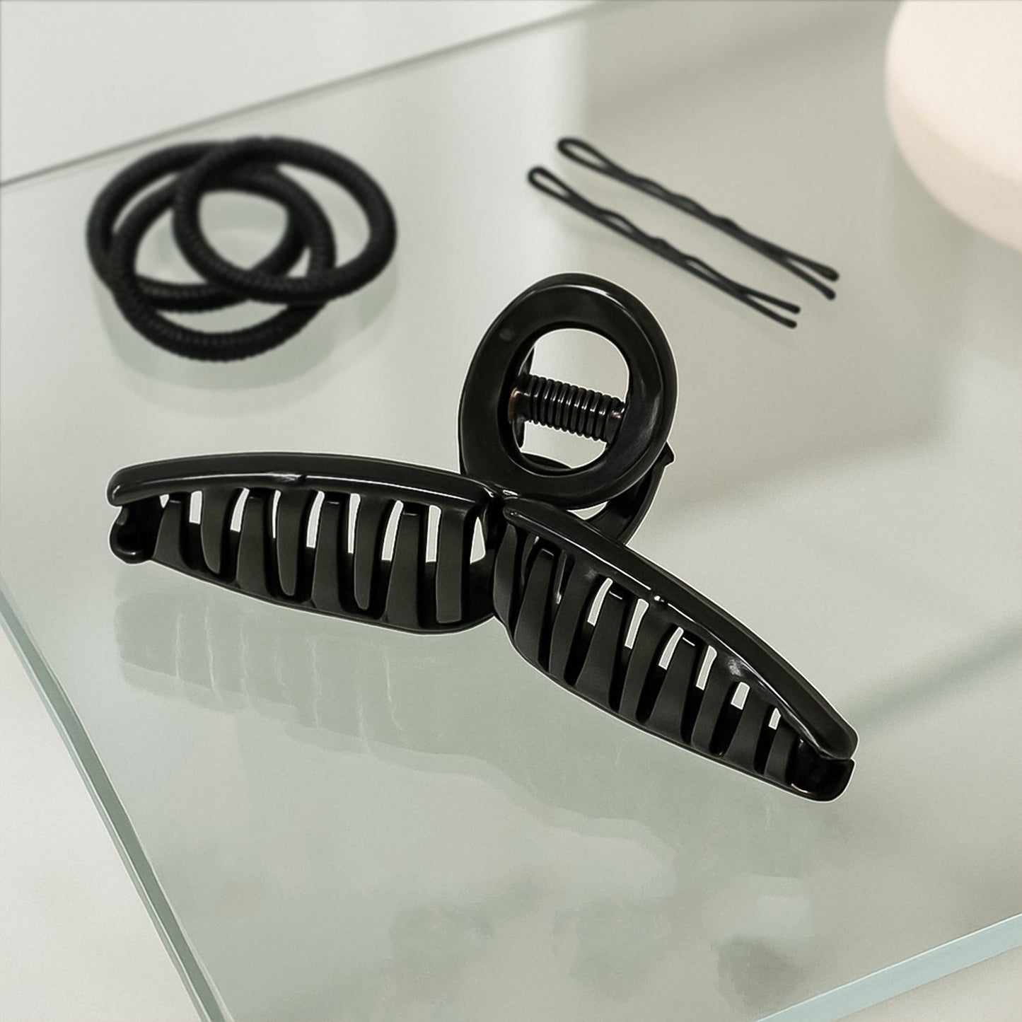 Back view of woman wearing hair claw clip holding elegant updo securely