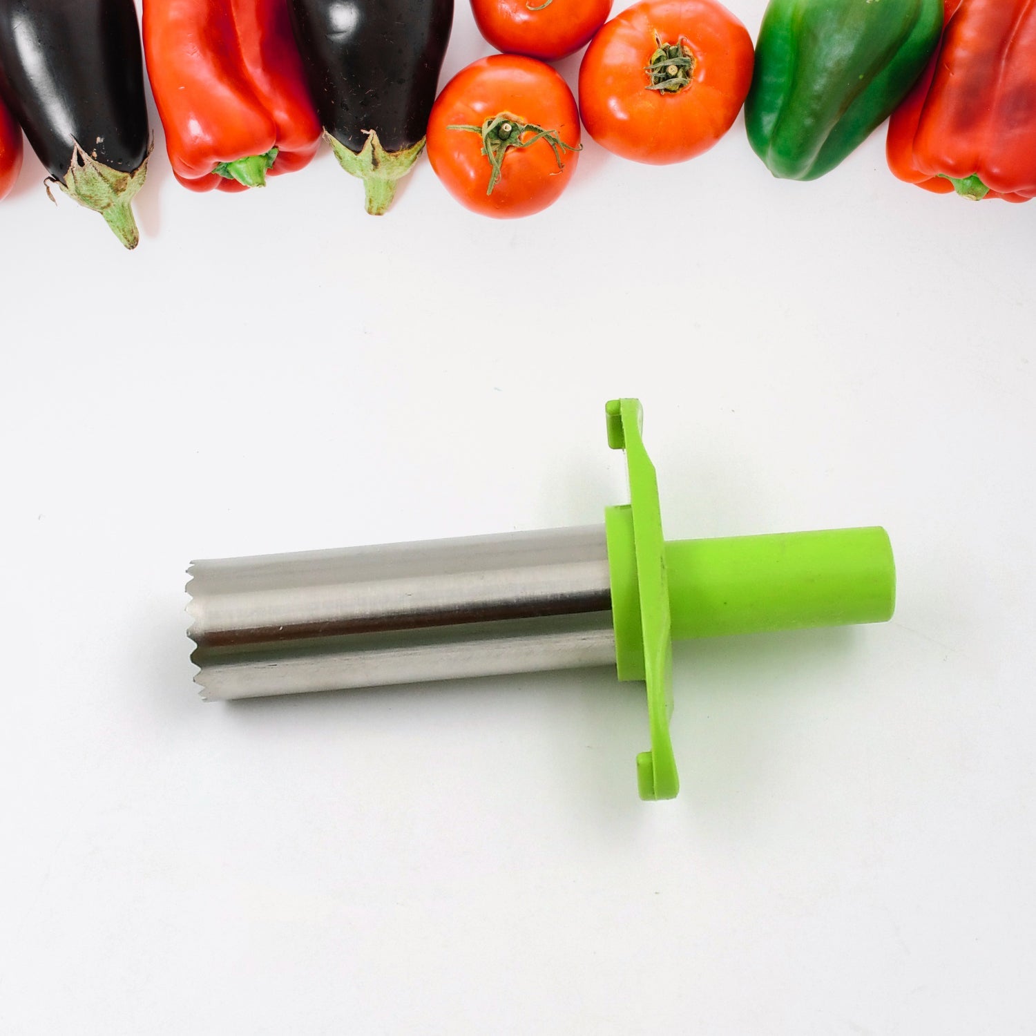 Chili corer in action, efficiently removing seeds from a fresh red pepper.