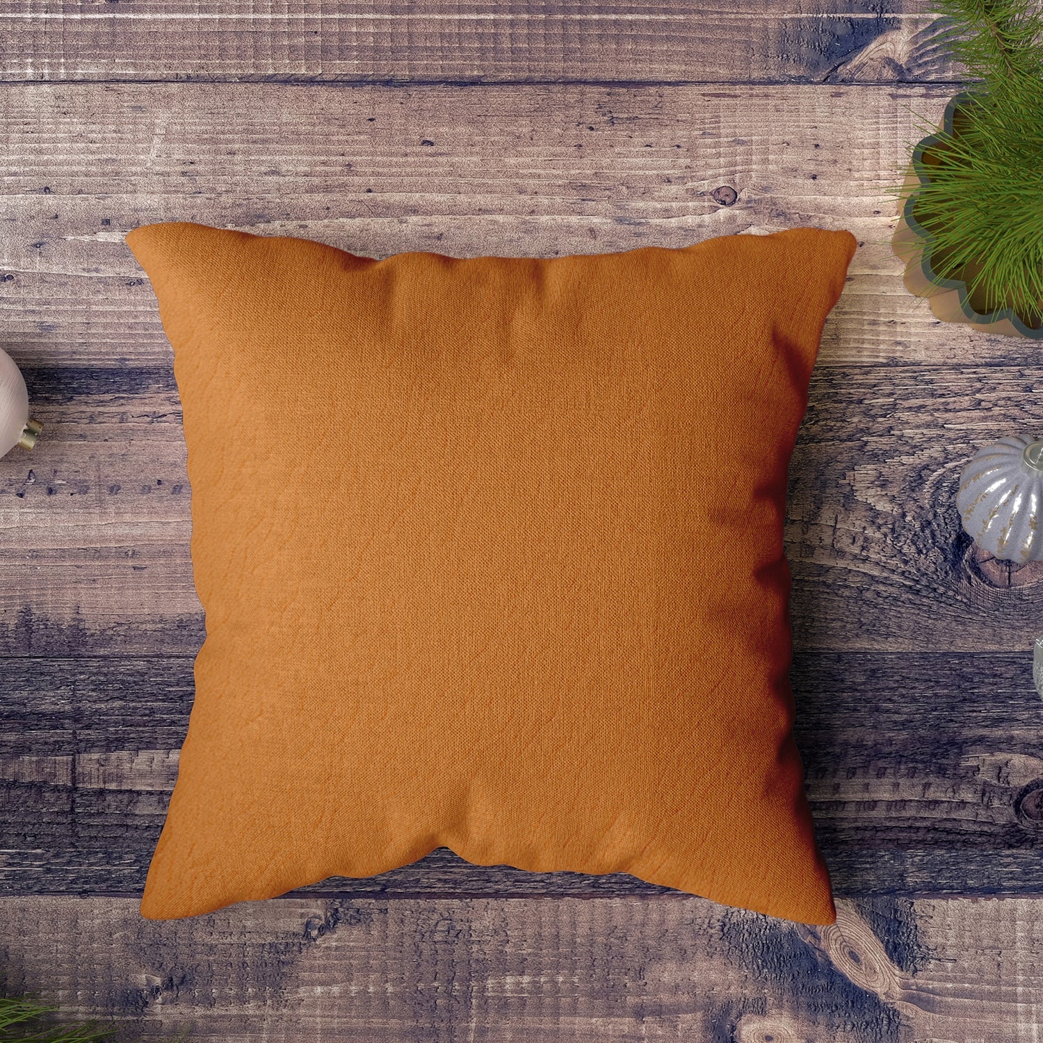 Multiple decorative pillow covers in various shades arranged on a couch.