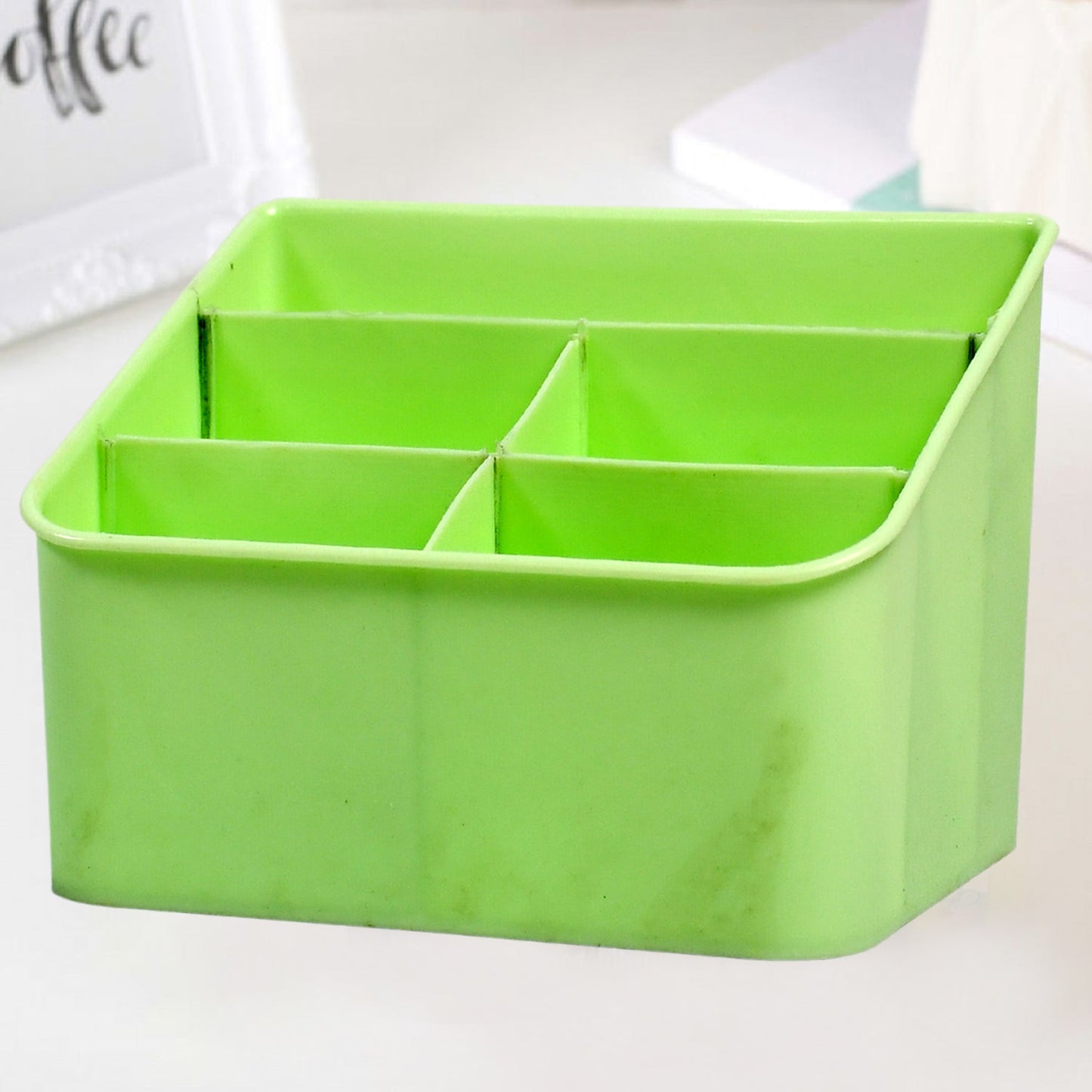 Clear plastic storage box holding cosmetics on a bathroom counter.