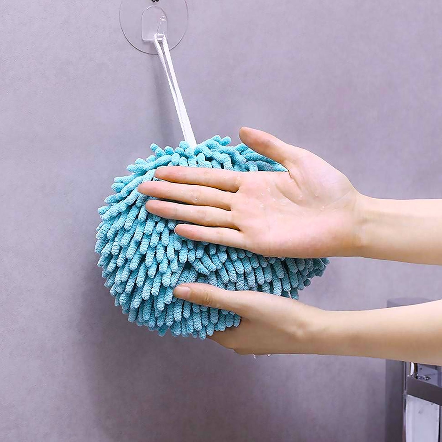 Hanging hand towel draped casually over a bathroom sink.