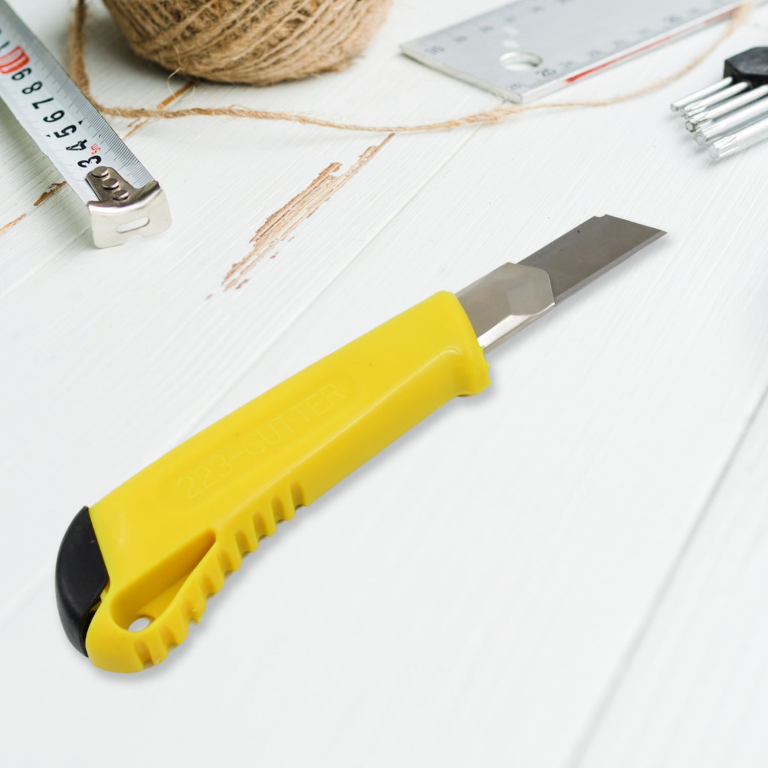 Detailed view of the durable blade and metal guide on the cutter knife.